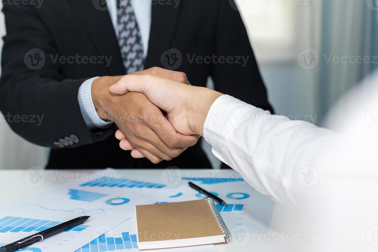 Welcome. business people shaking hands after business signing contract in meeting room at company office, partner, job interview, investor, negotiation, partnership, teamwork, financial concept photo