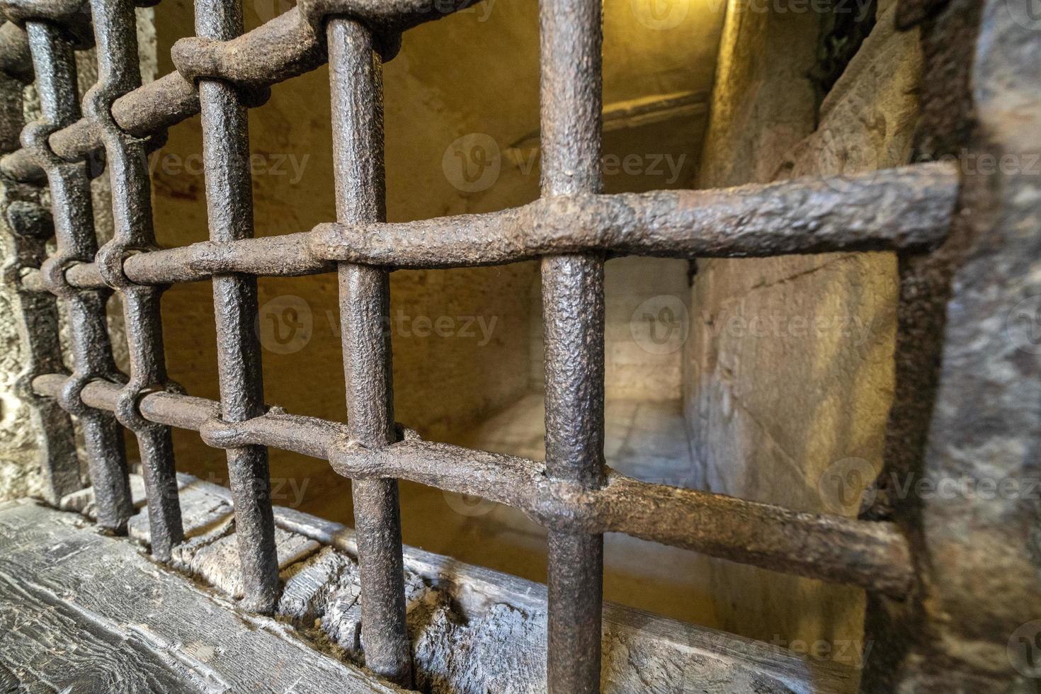 medieval cellar prison iron bars grate photo