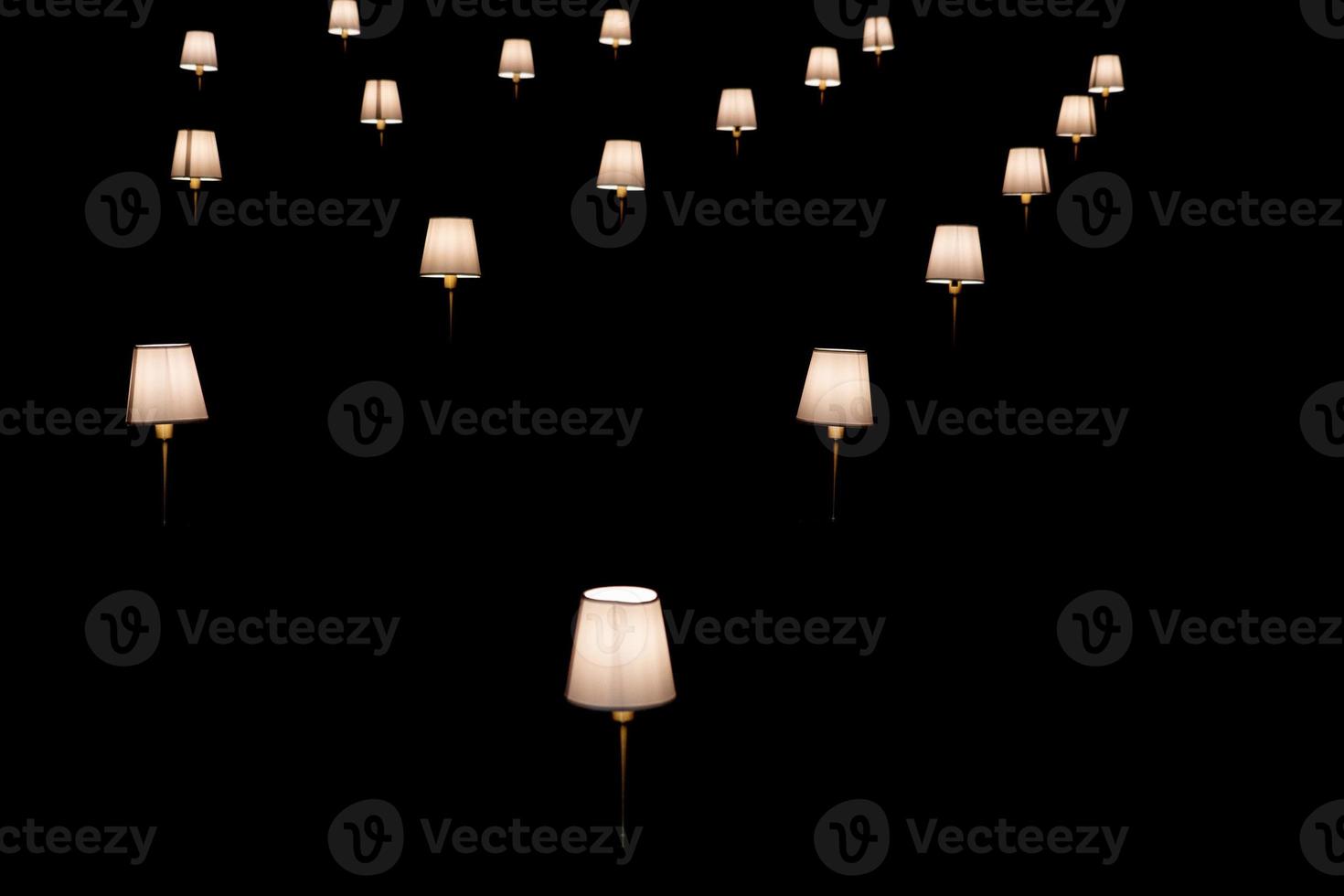 many lamps isolated on black photo