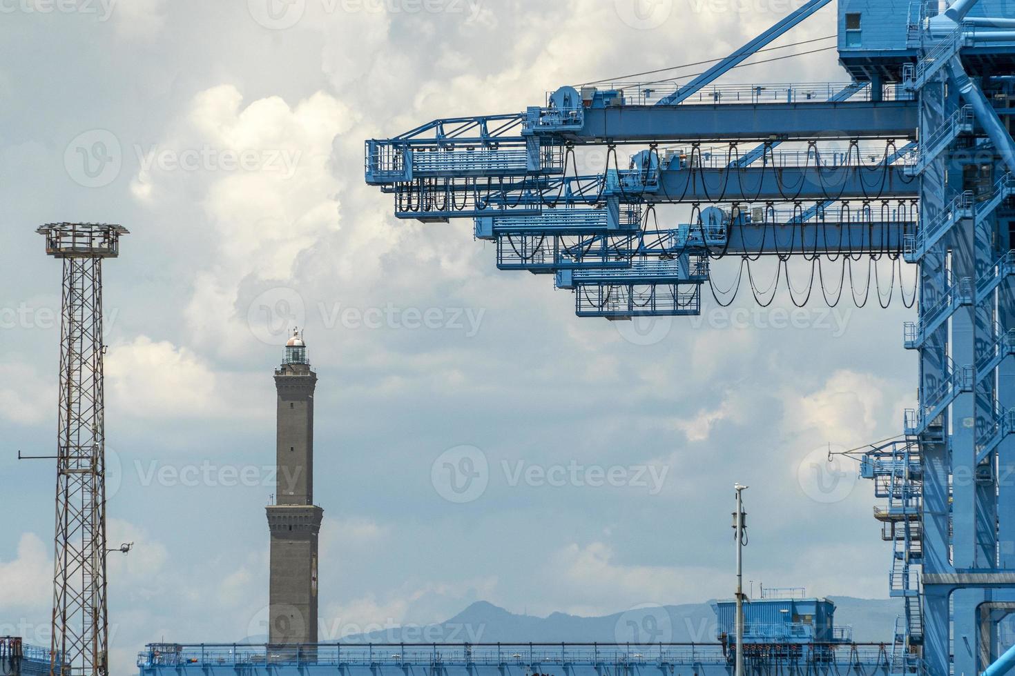 container cranes harbour working place in genoa lanterna lighthouse photo