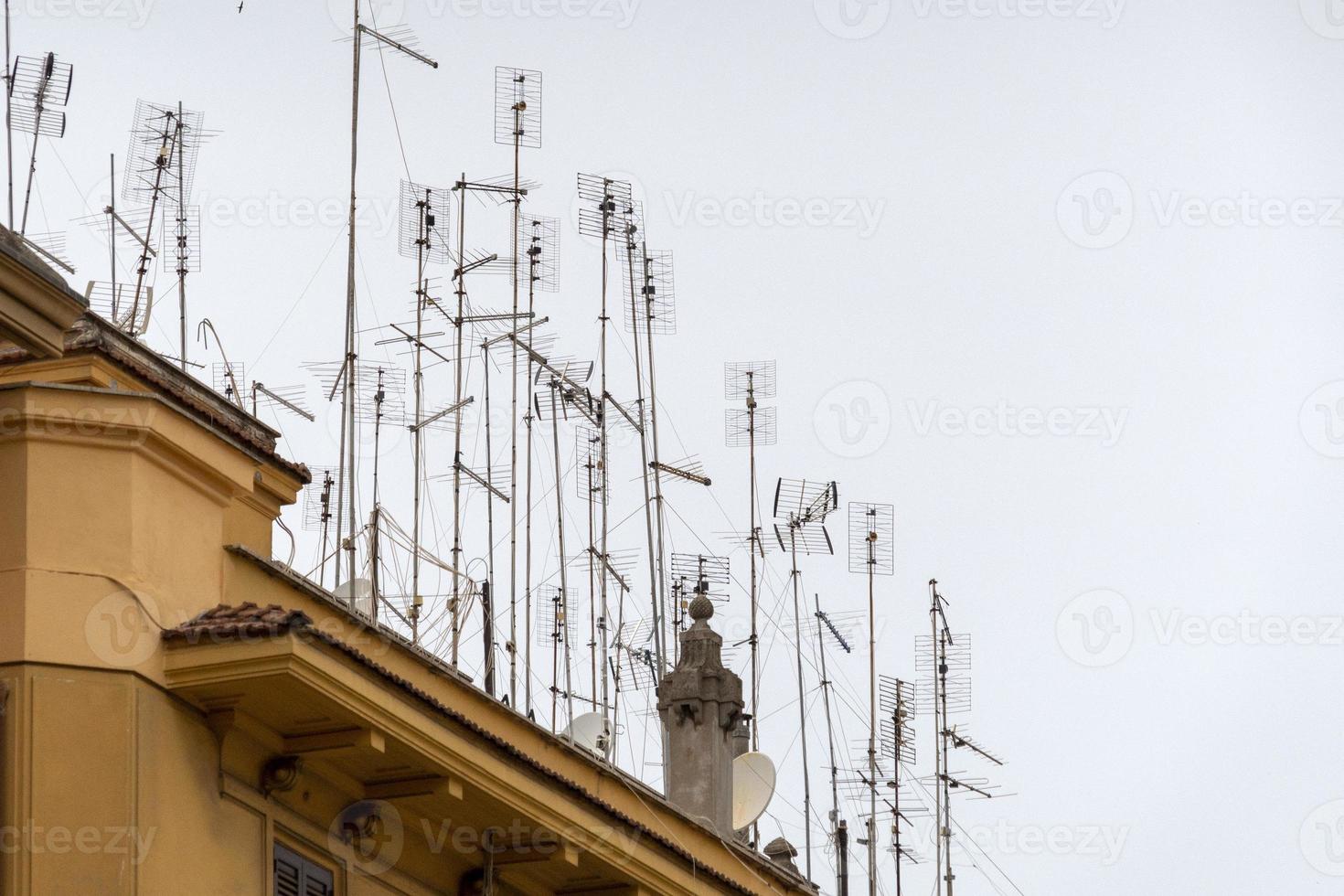 Many television antennas in rome building photo