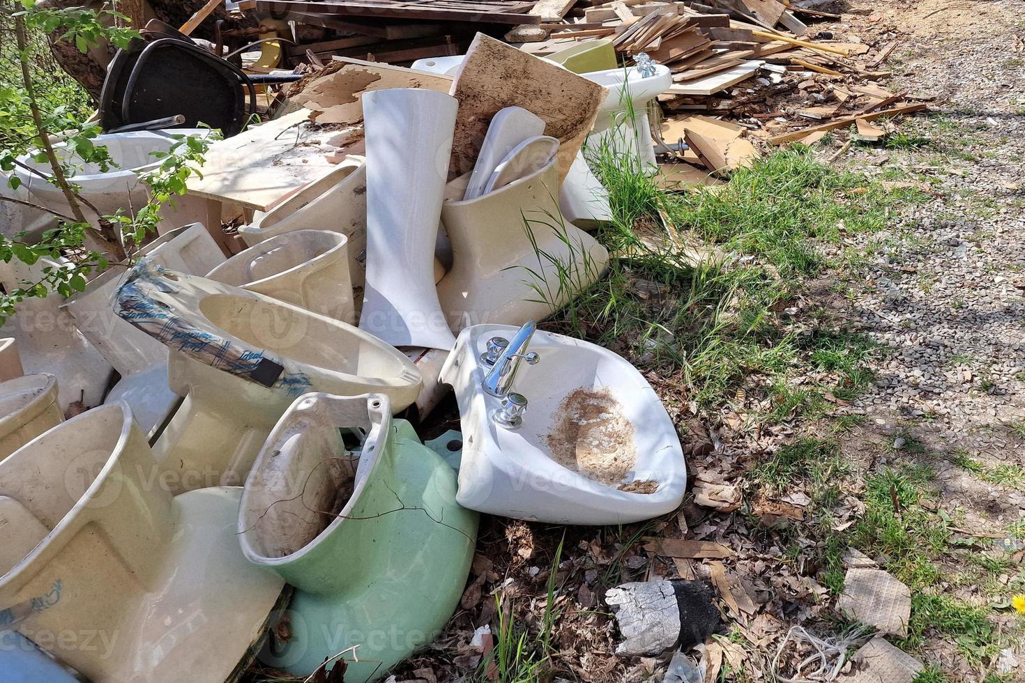 Many old abandoned ceramic toilet wc sinker photo