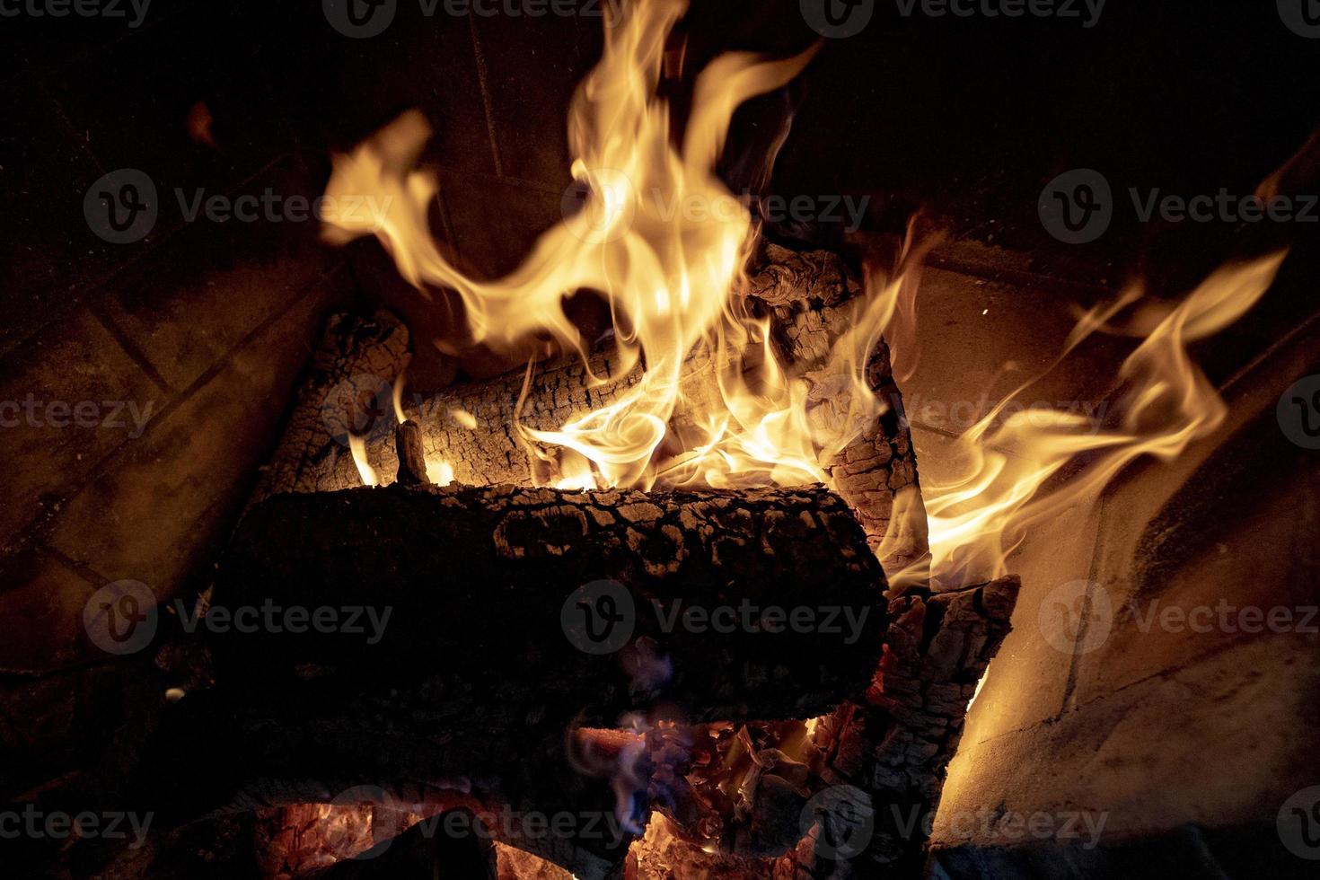 Flames on wood in fireplace photo