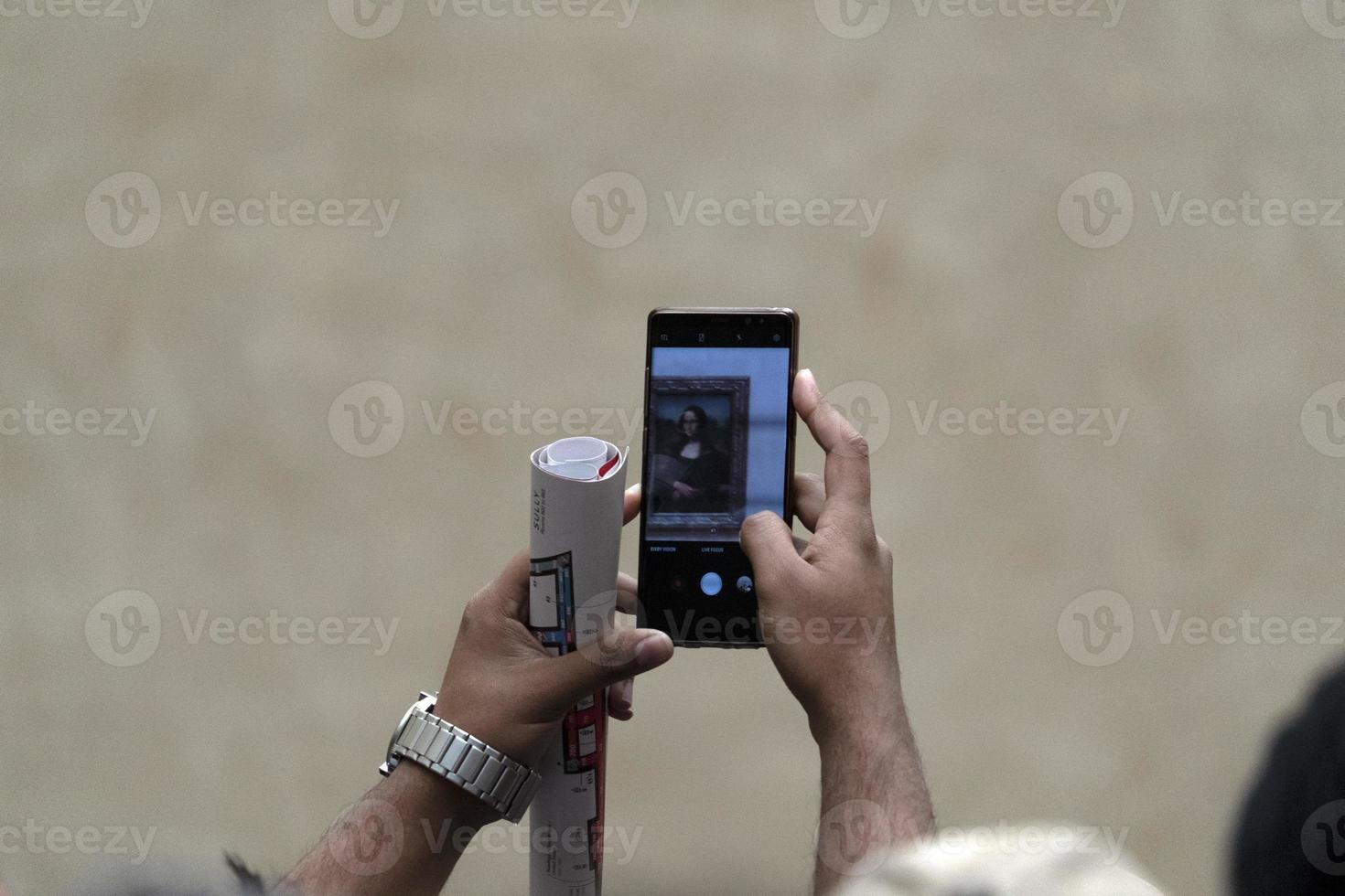 PARIS, FRANCE -OCTOBER 7, 2018 - Mona Lisa painting Louvre hall crowded of tourist photo