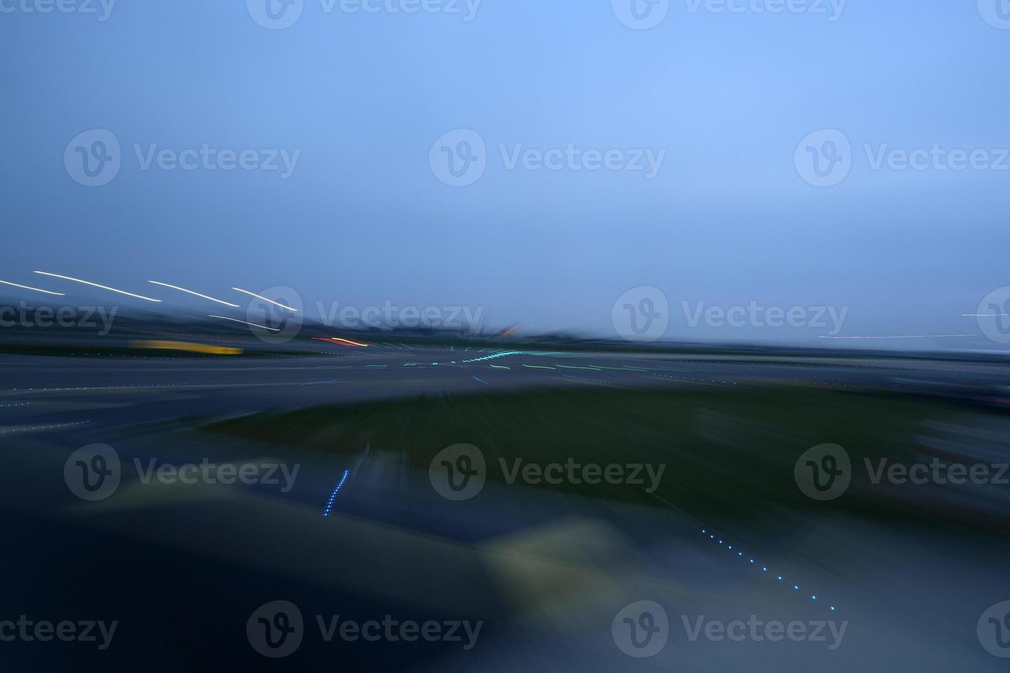 airport lights in motion while taking off at night photo