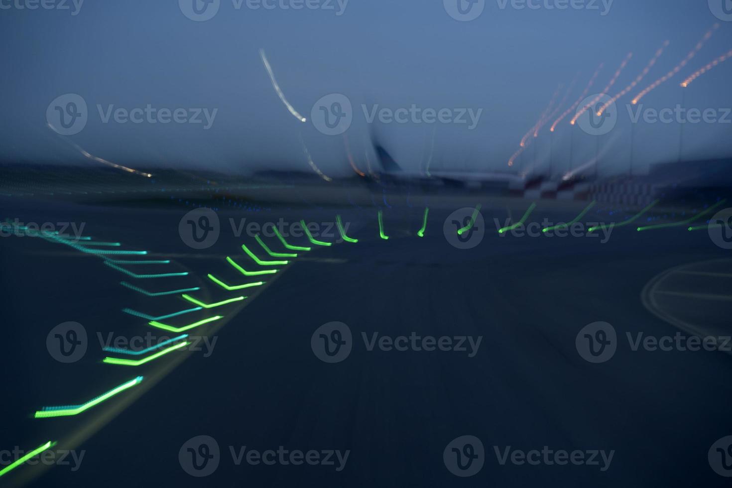 airport lights in motion while taking off at night photo
