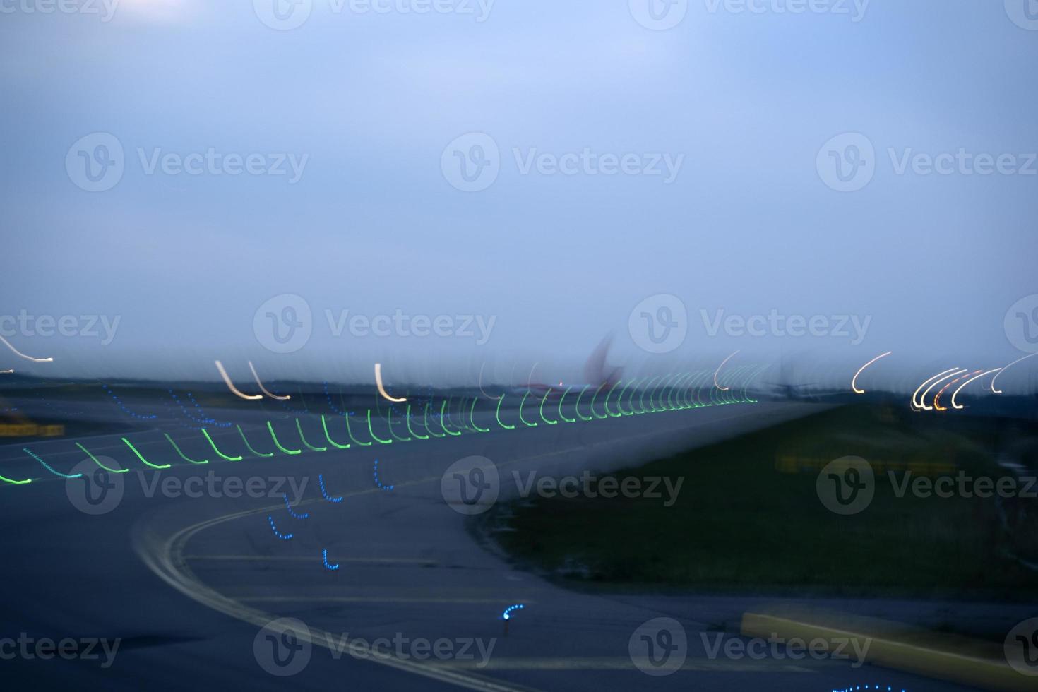 airport lights in motion while taking off at night photo