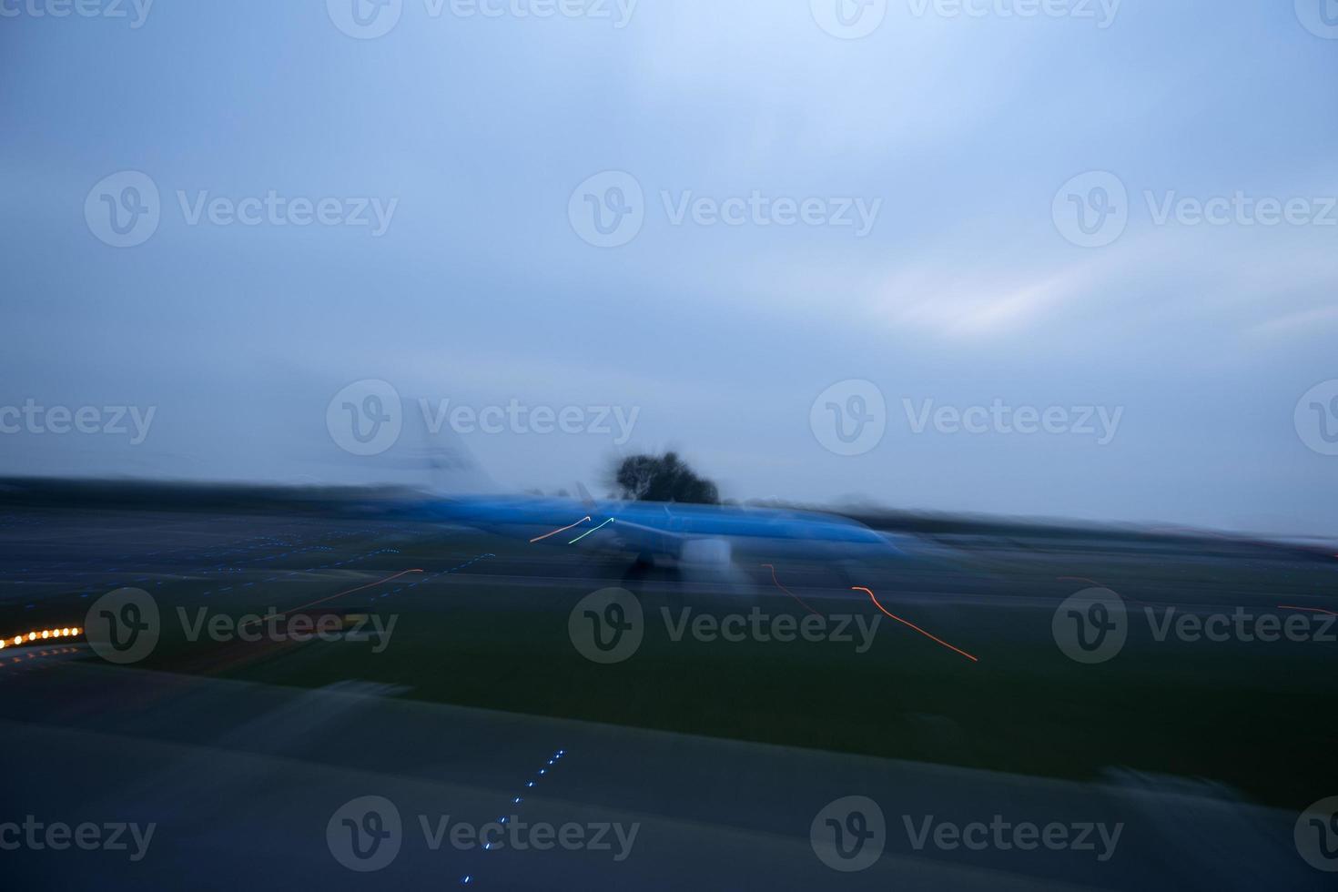 airport lights in motion while airplane taking off at night photo