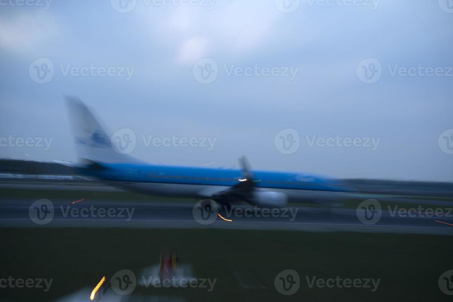 airport lights in motion while airplane taking off at night photo