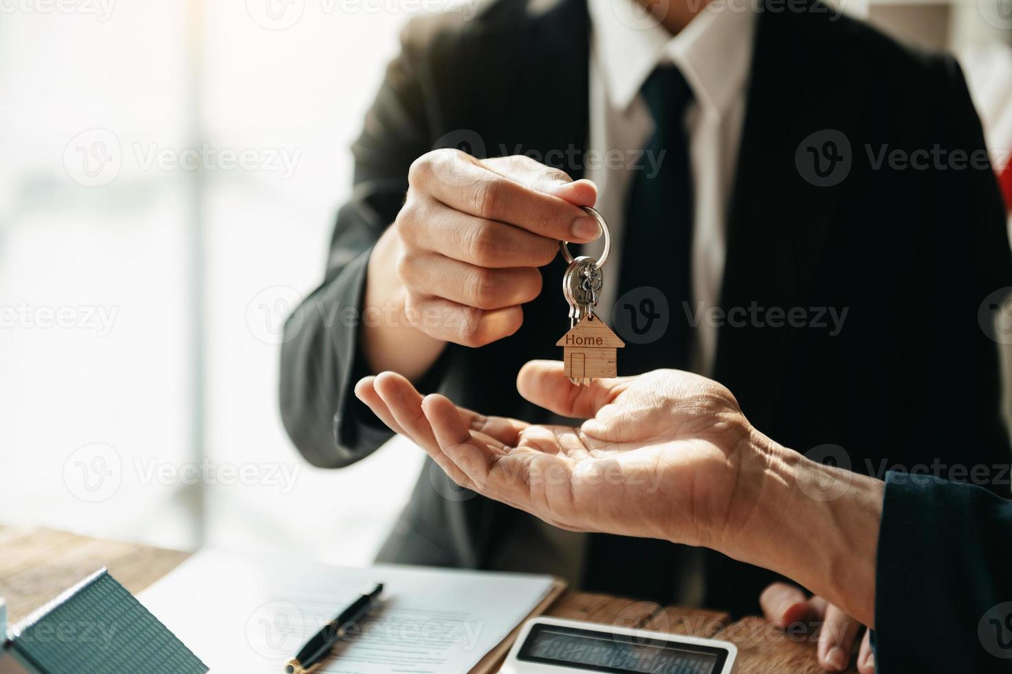 Buying a home or insurance deal, an insurance agent pointing a pen to those interested in renting a house, a contract, signing an Home buying agreement in office photo