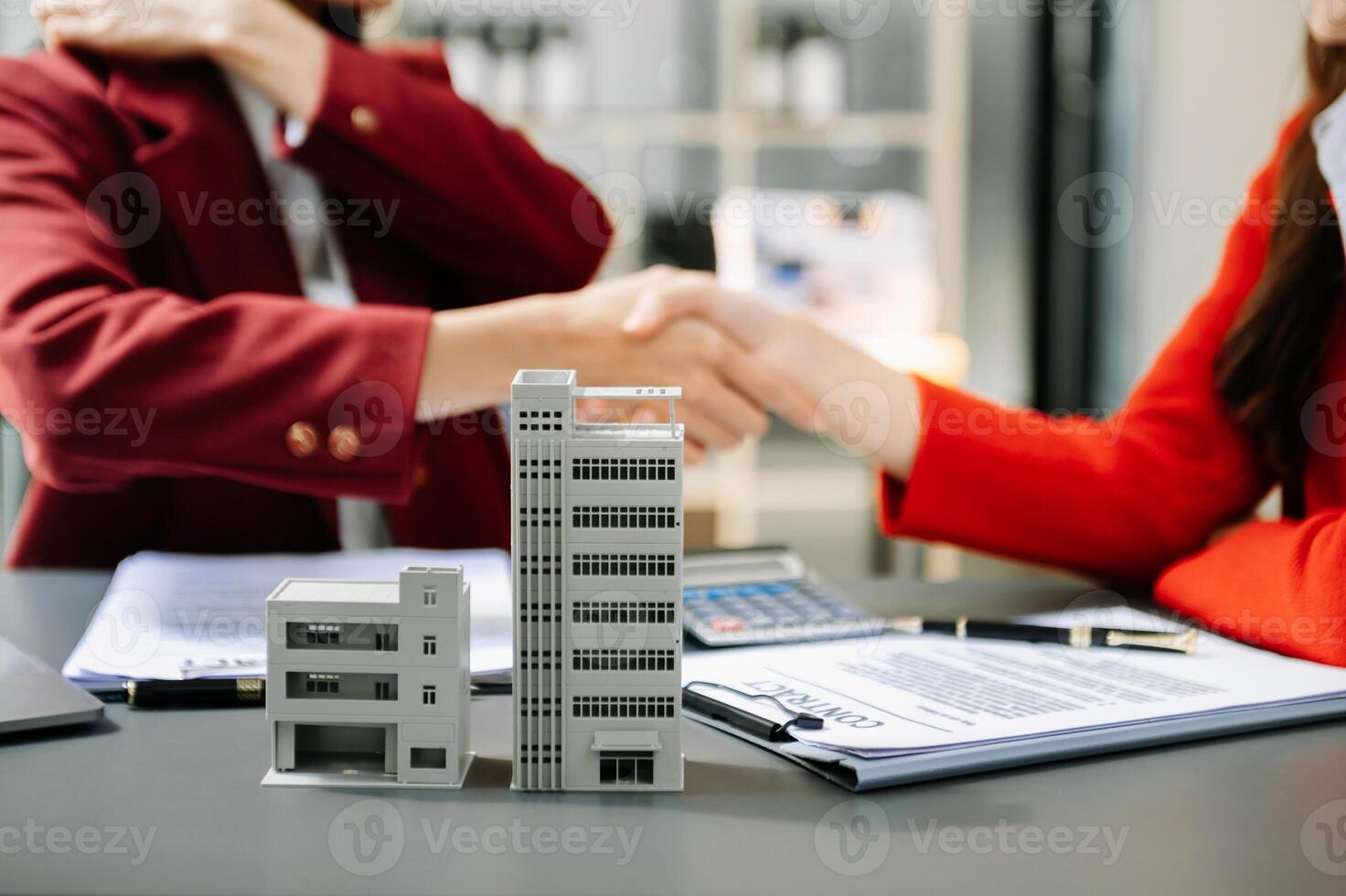 Signing a contract. Client and broker agent, lease agreement, successful deal and  Young business sitting at the desk in office photo