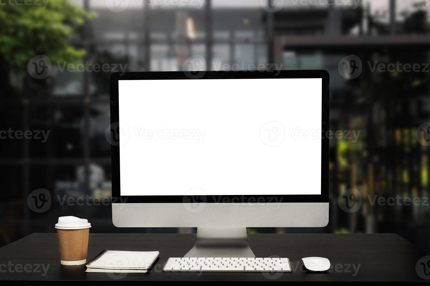 workspace with computer, laptop, office supplies, and coffee cup, smartphone, and tablet at office. desk work concept. in morning light photo