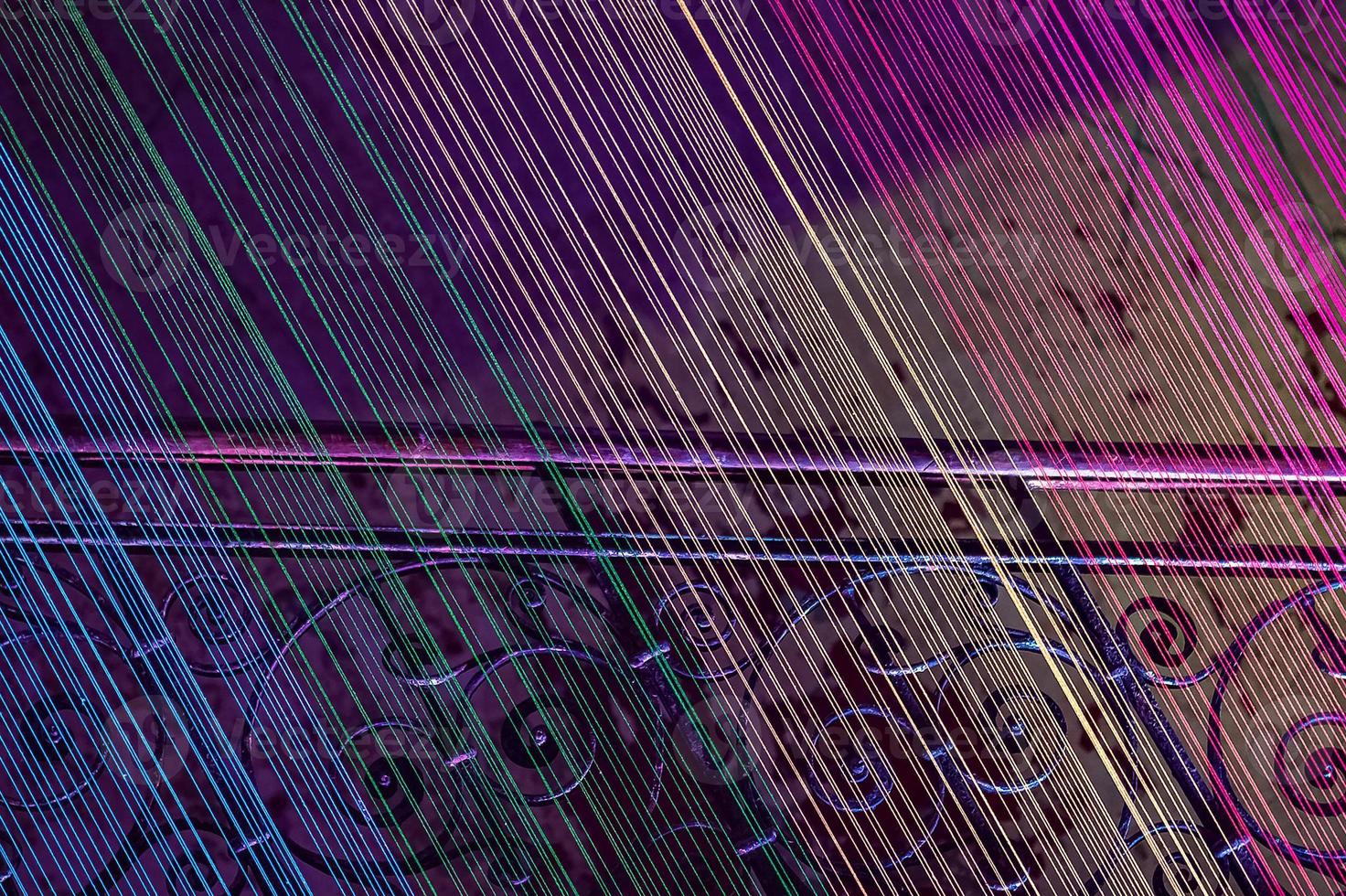 A flight of stairs with stretched threads illuminated with all the colors of the rainbow. Neon light, abstract photo