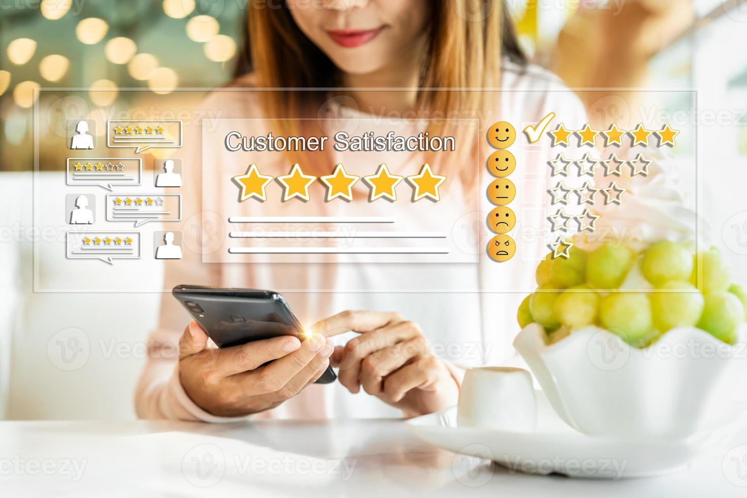 Young woman traveler using smartphone to give a five-star satisfaction rating of the food and drinks at restaurant on social media, Travel lifestyle concept photo