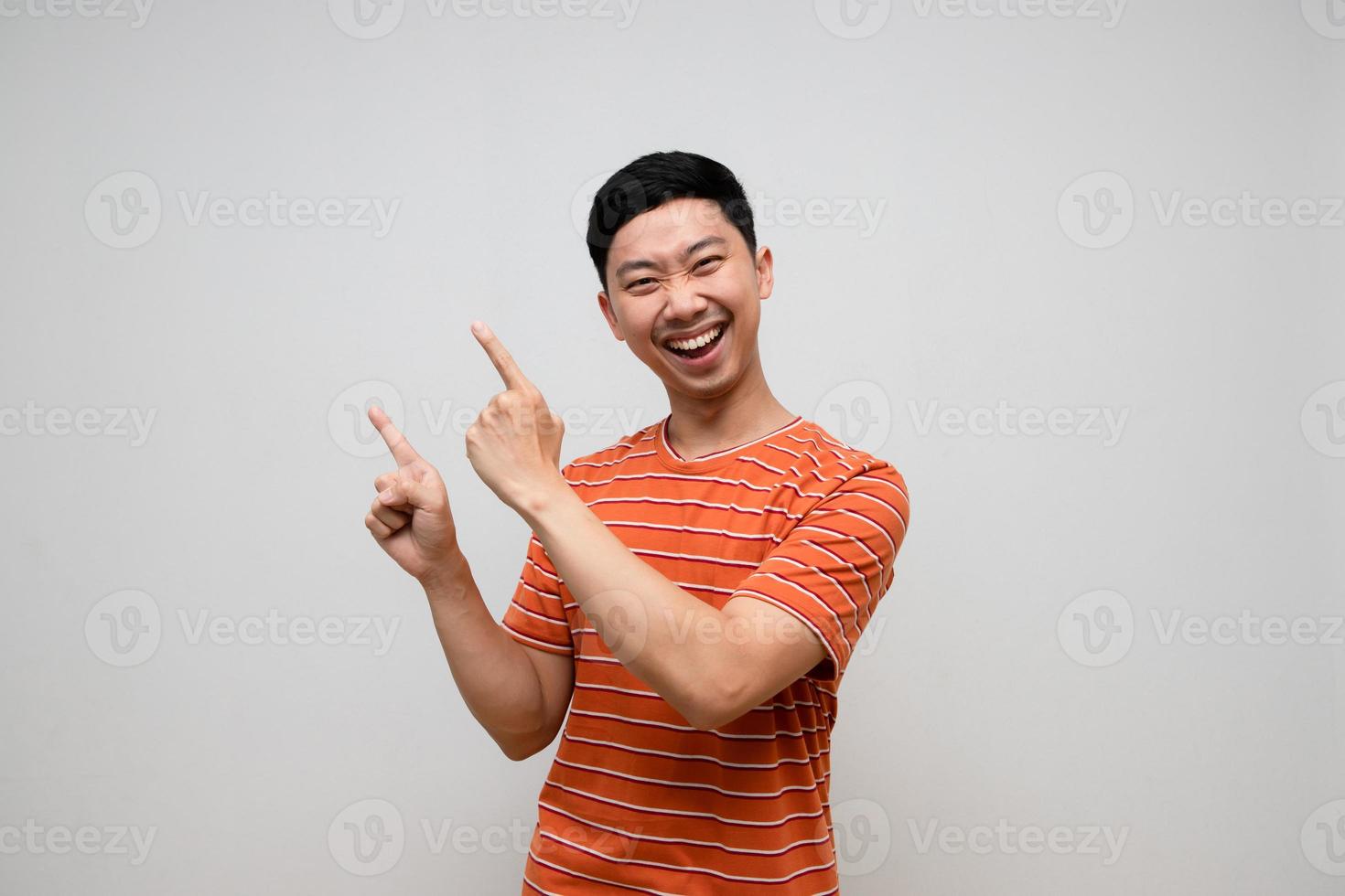 Positive asian man striped shirt happiness smile gesture point finger isolated photo