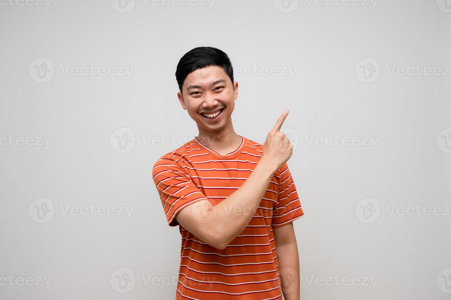 Positive asian man striped shirt happiness smile gesture point finger isolated photo