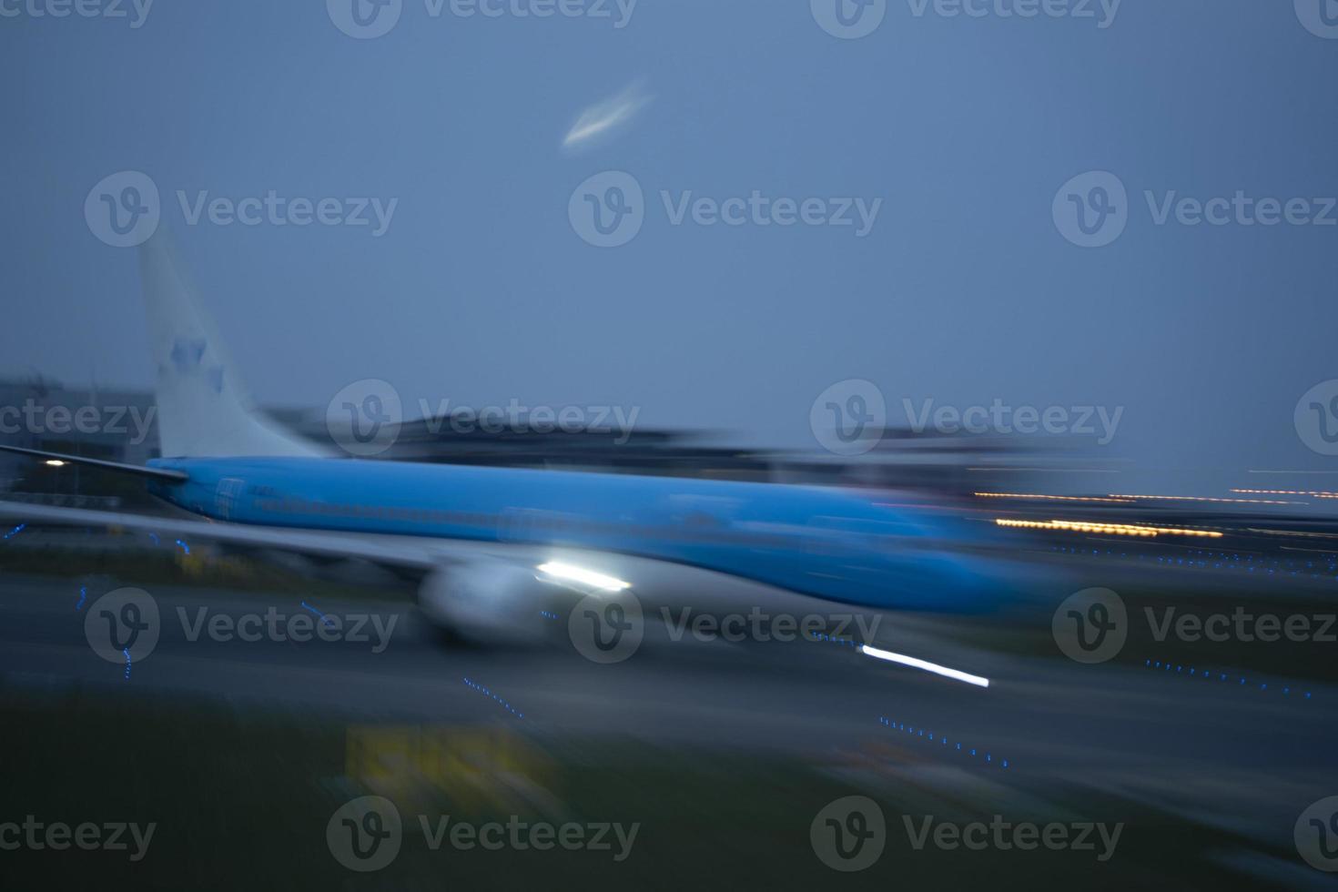 airport lights in motion while airplane taking off at night photo