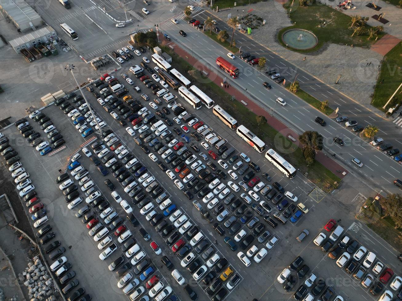 Aerial view over huge outdoor parking lots with many cars and vehicles photo