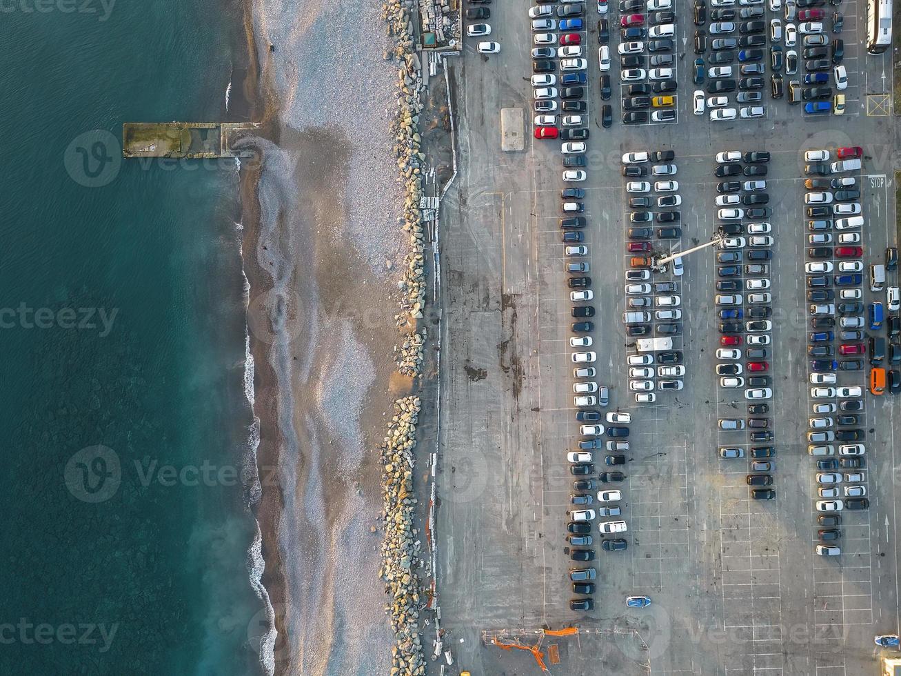 Aerial view over huge outdoor parking lots with many cars and vehicles photo