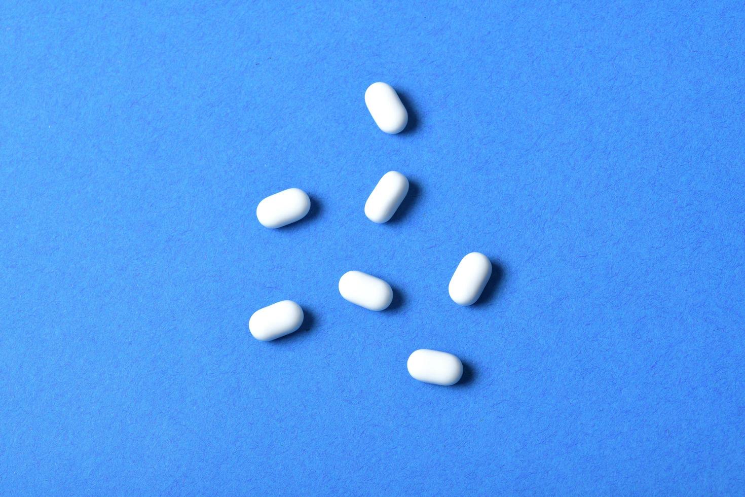 Top view of tic tac bonbons isolated on blue background photo