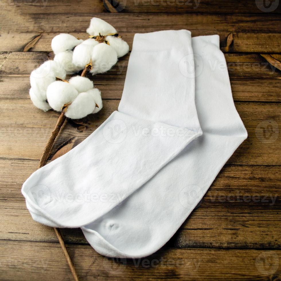 White socks and cotton are on the table. photo