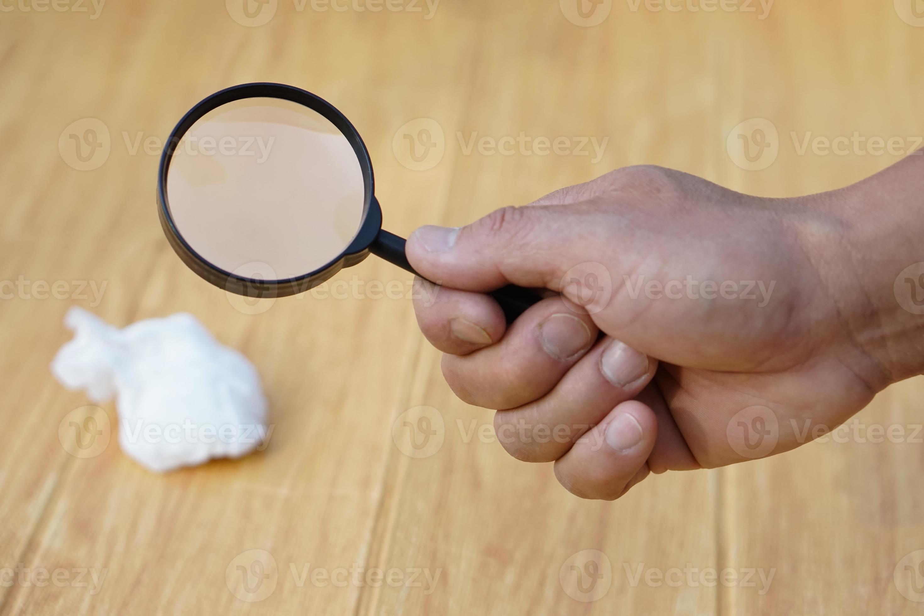 Close Up hand held magnifying glass to do science experiment about hot