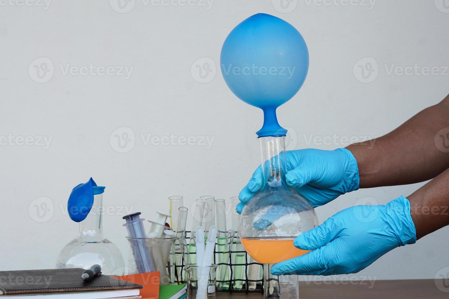 Student do science experiment, lab lesson, transparent bottles with inflated balloons on top of bottle. The experiment about air or gas reaction by using chemical substances. Education Science subject photo