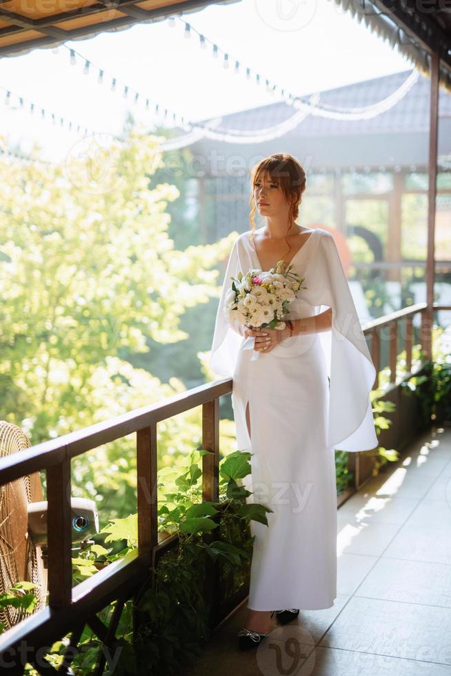 bride in a white dress with a bouquet photo
