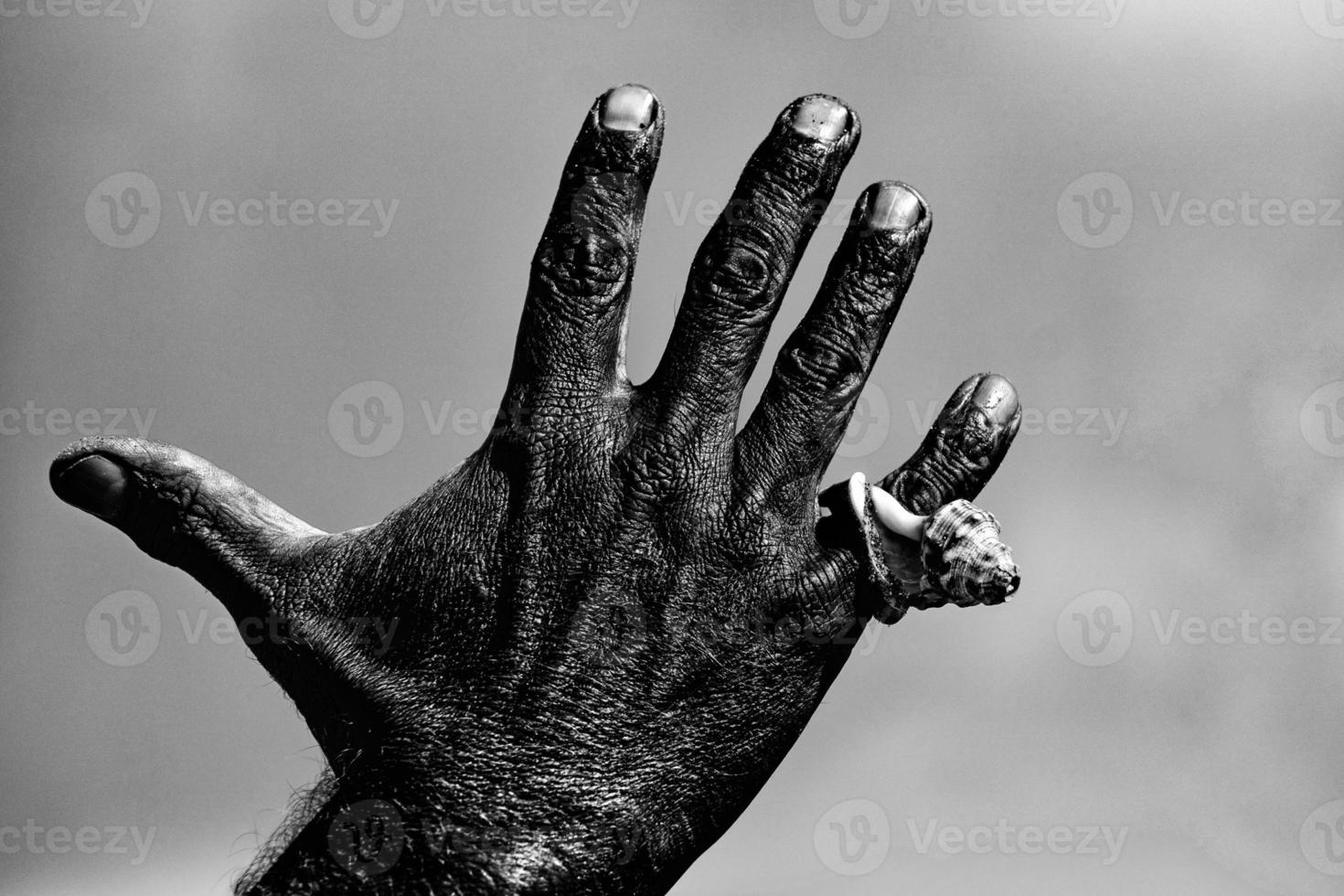 black man Hand with a shell in the sky photo