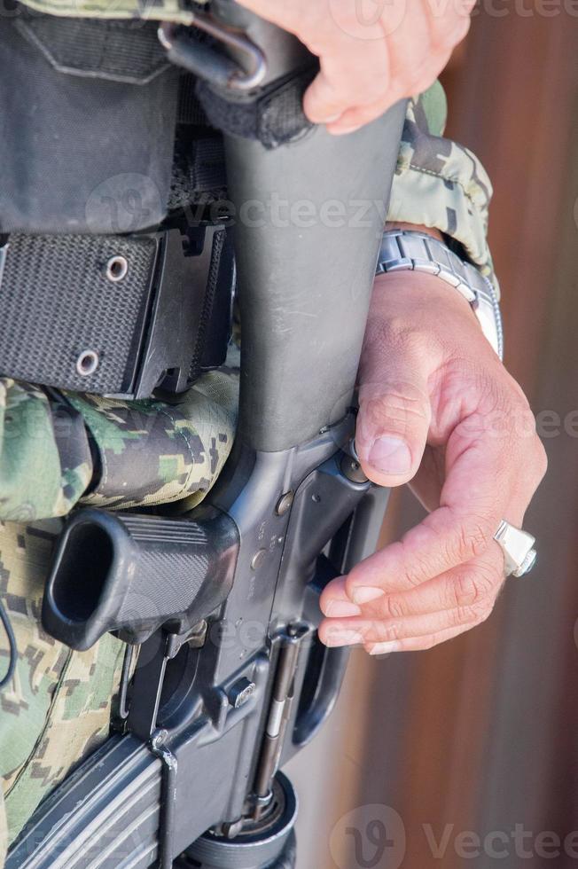 soldier hands holding machine gun photo