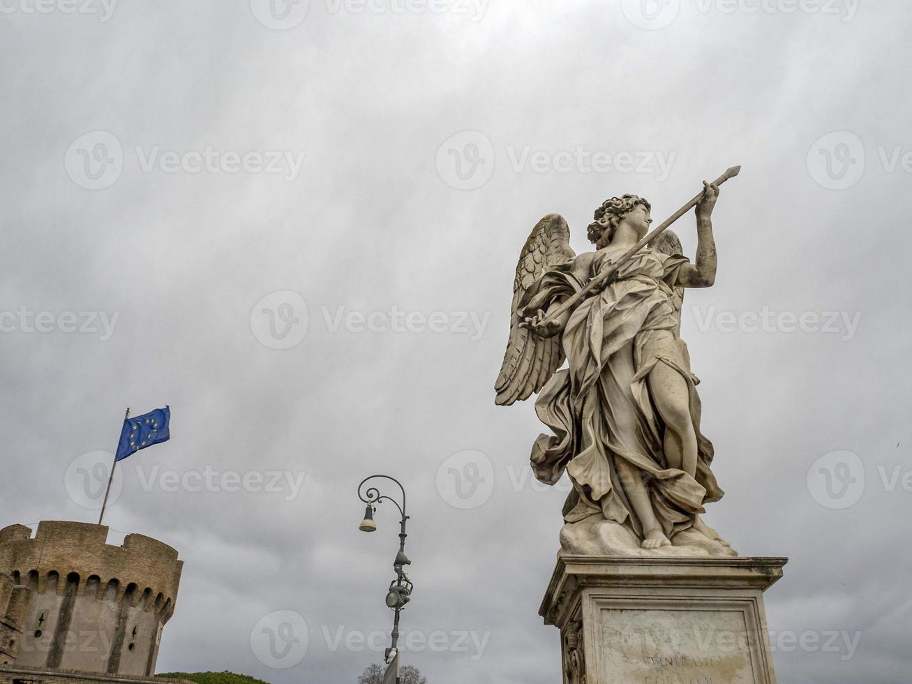 statue on bridge near on castel sant angelo rome photo