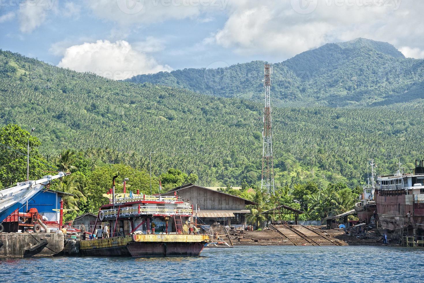 rusty rugged ship in indonesia harbor photo