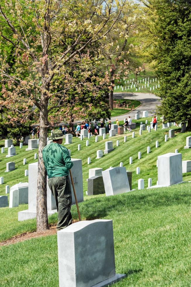 WASHINGTON D.C., USA - MAY, 2 2014 - worker is cleaning tombstones at Arlington cemetery photo