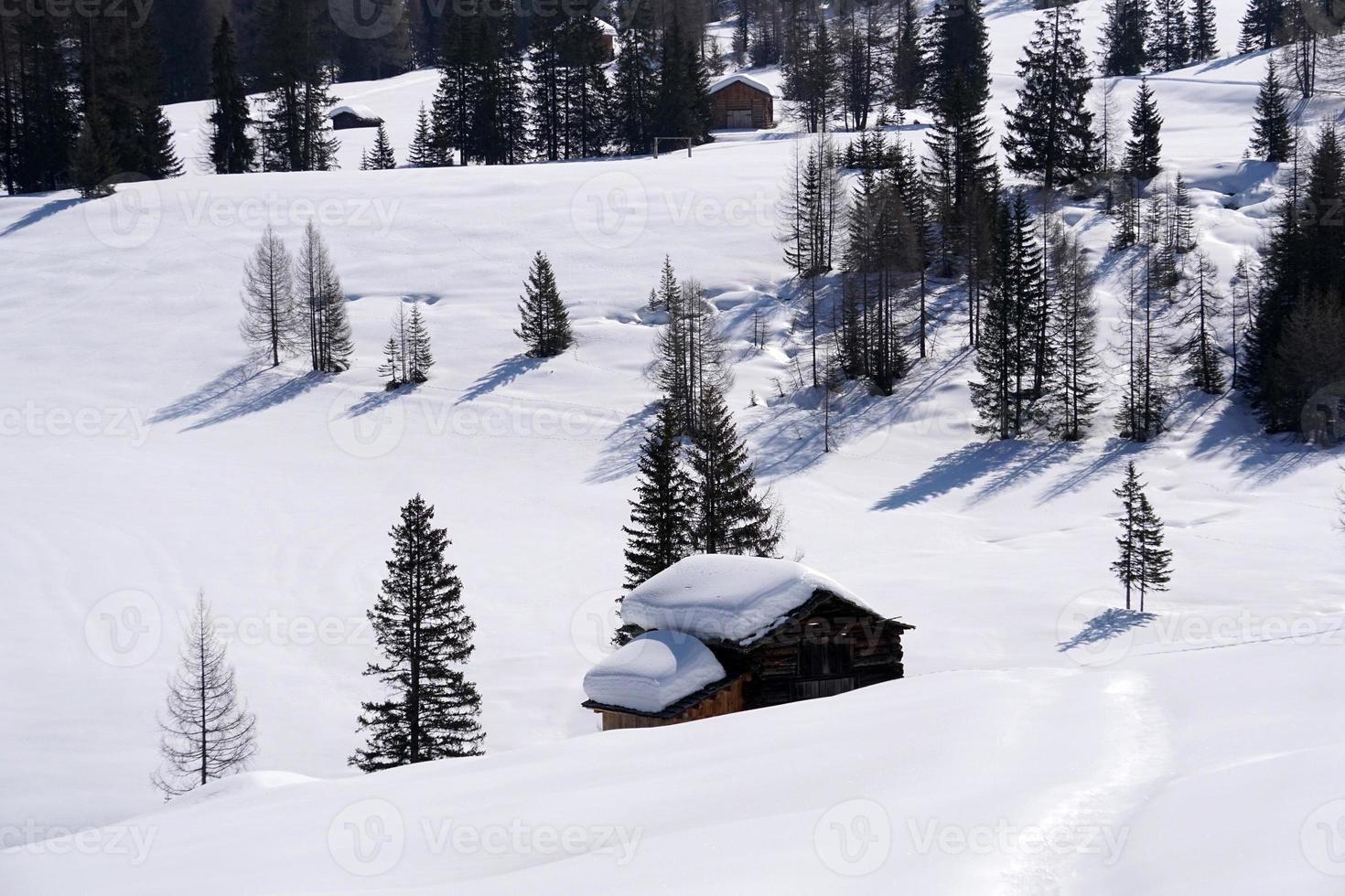 wood cabin hut in the winter snow background photo