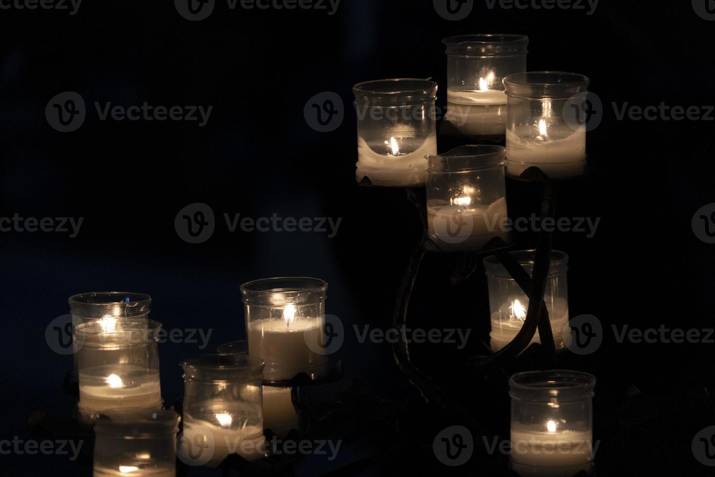 votive candles inside a church isolated on black photo