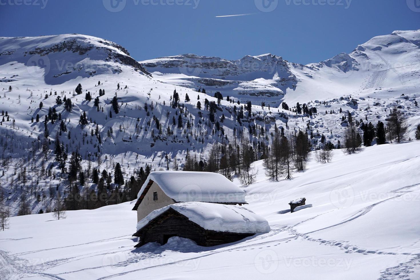 dolomites snow panorama big landscape hut covered by snow photo