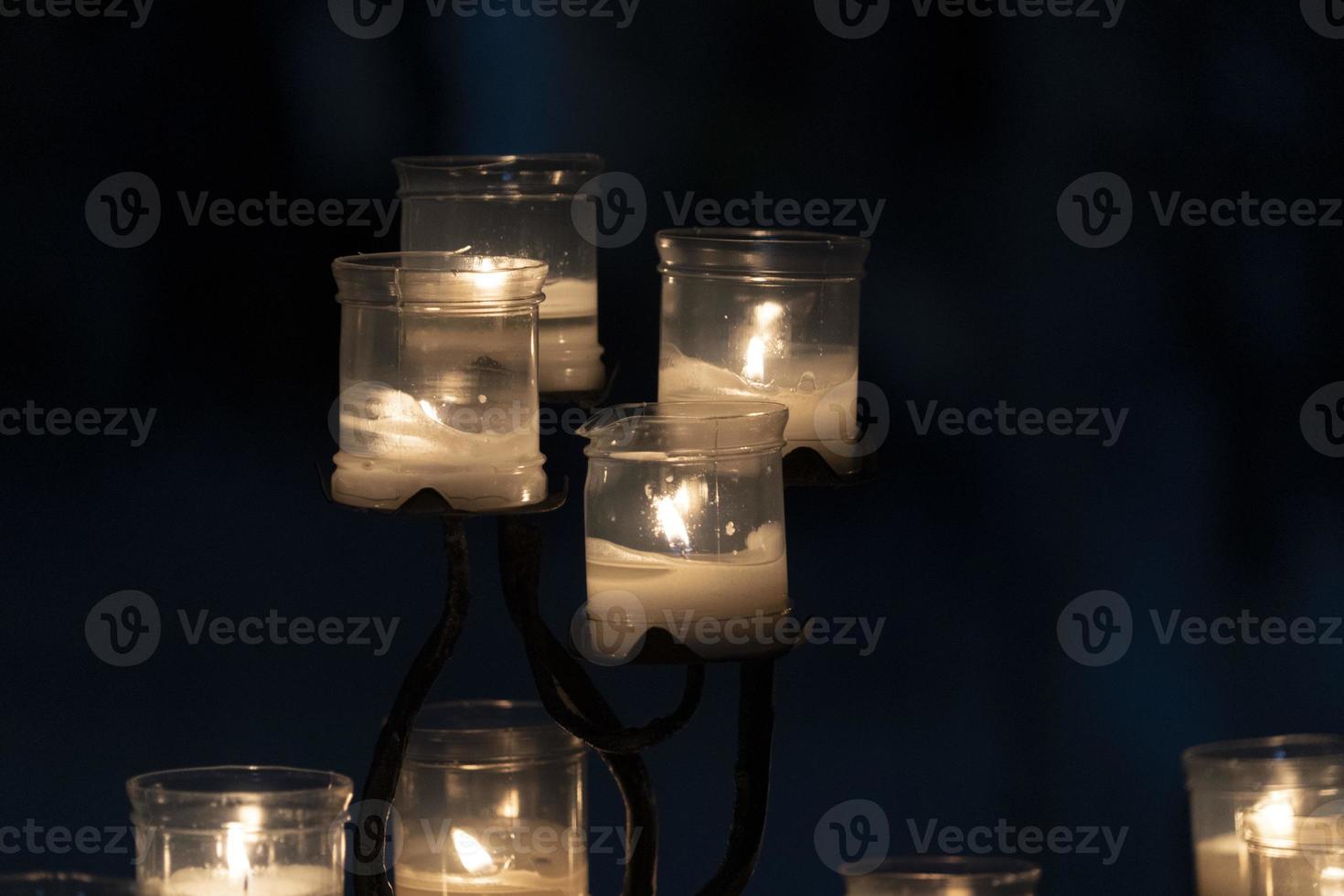 votive candles inside a church isolated on black photo