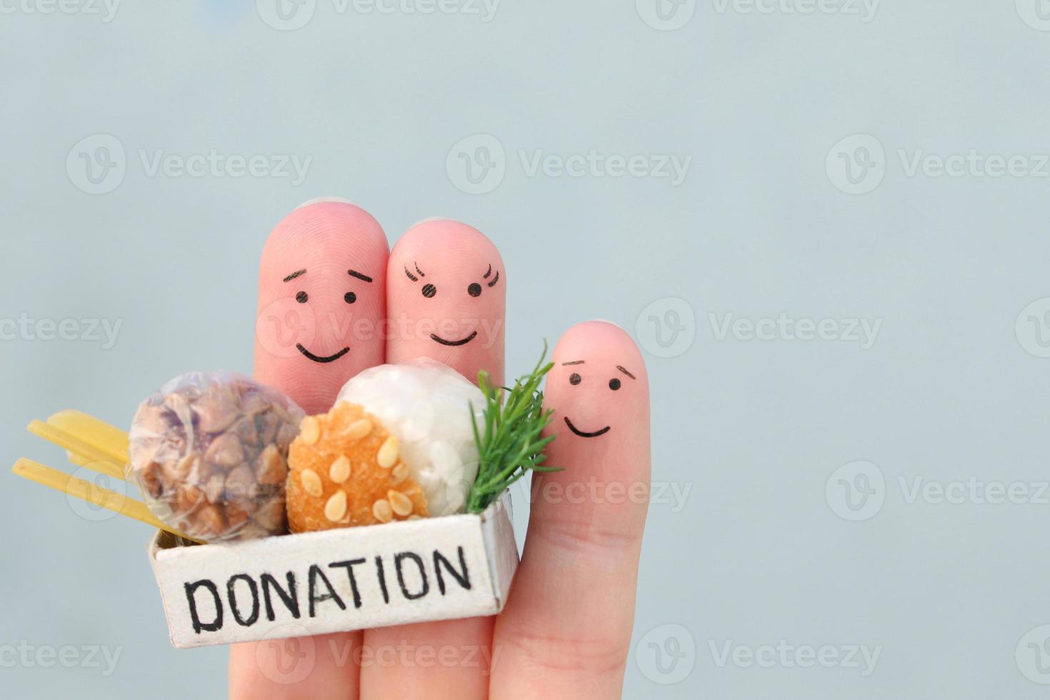 Fingers art of family. Man  and woman holding donation box with food. photo