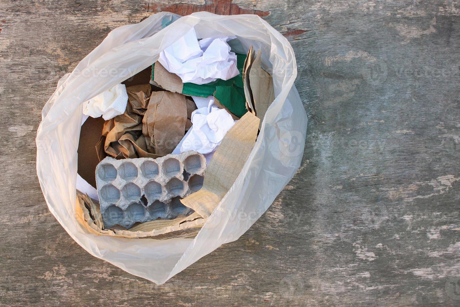 Garbage bag with different paper trash. Garbage sorting. photo