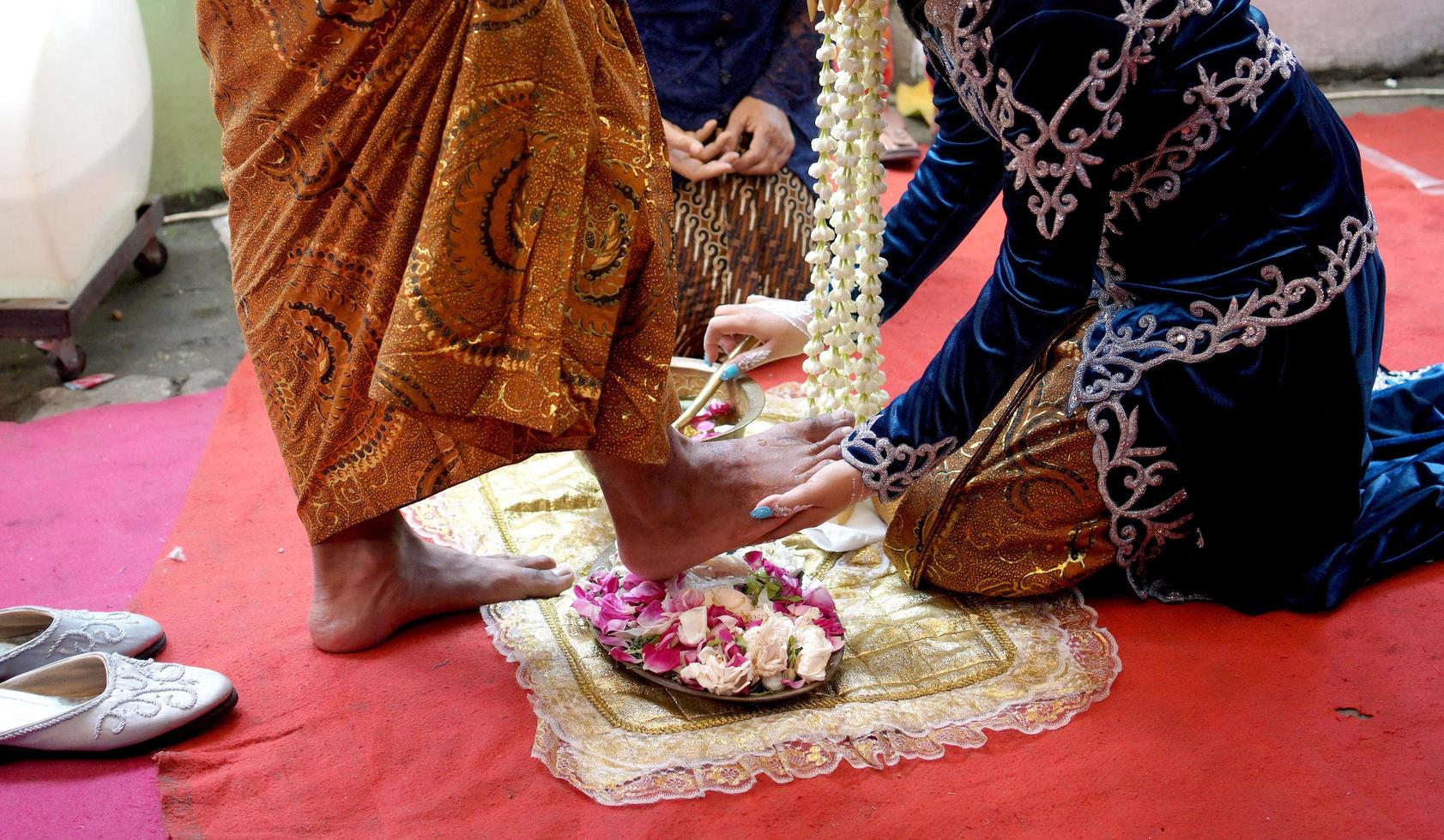 Bride Washes Groom's Feet in Traditional Wedding Ceremony photo