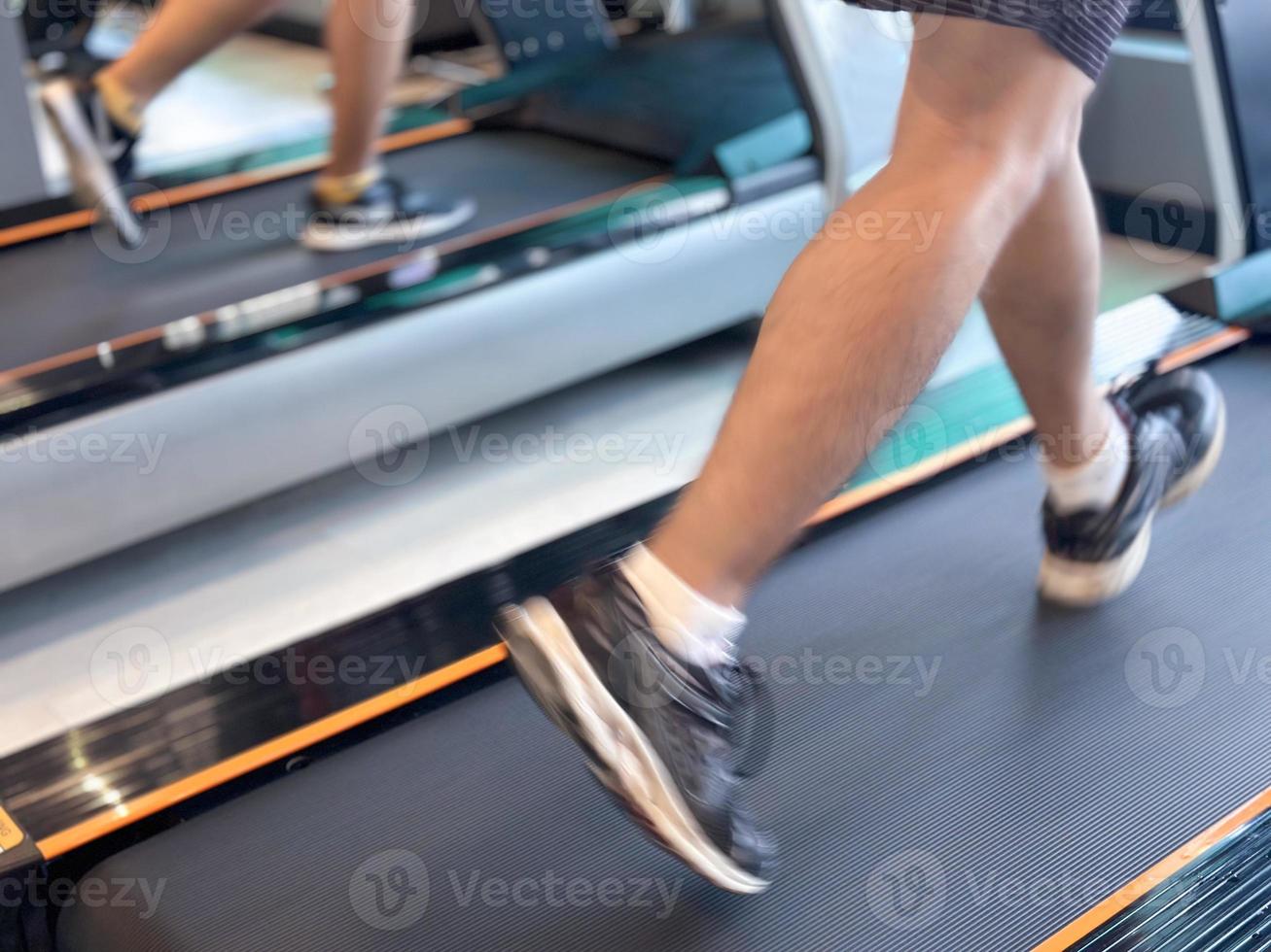 Blur image about man exercising on walking treadmill at gym. Concept for healthy and lose weight. photo