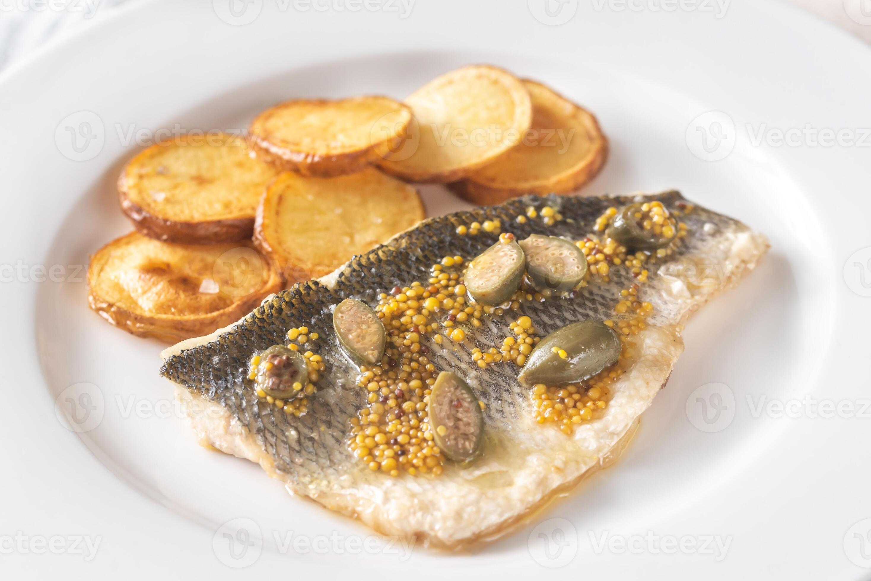 Baked sea bass with capers 18772153 Stock Photo at Vecteezy