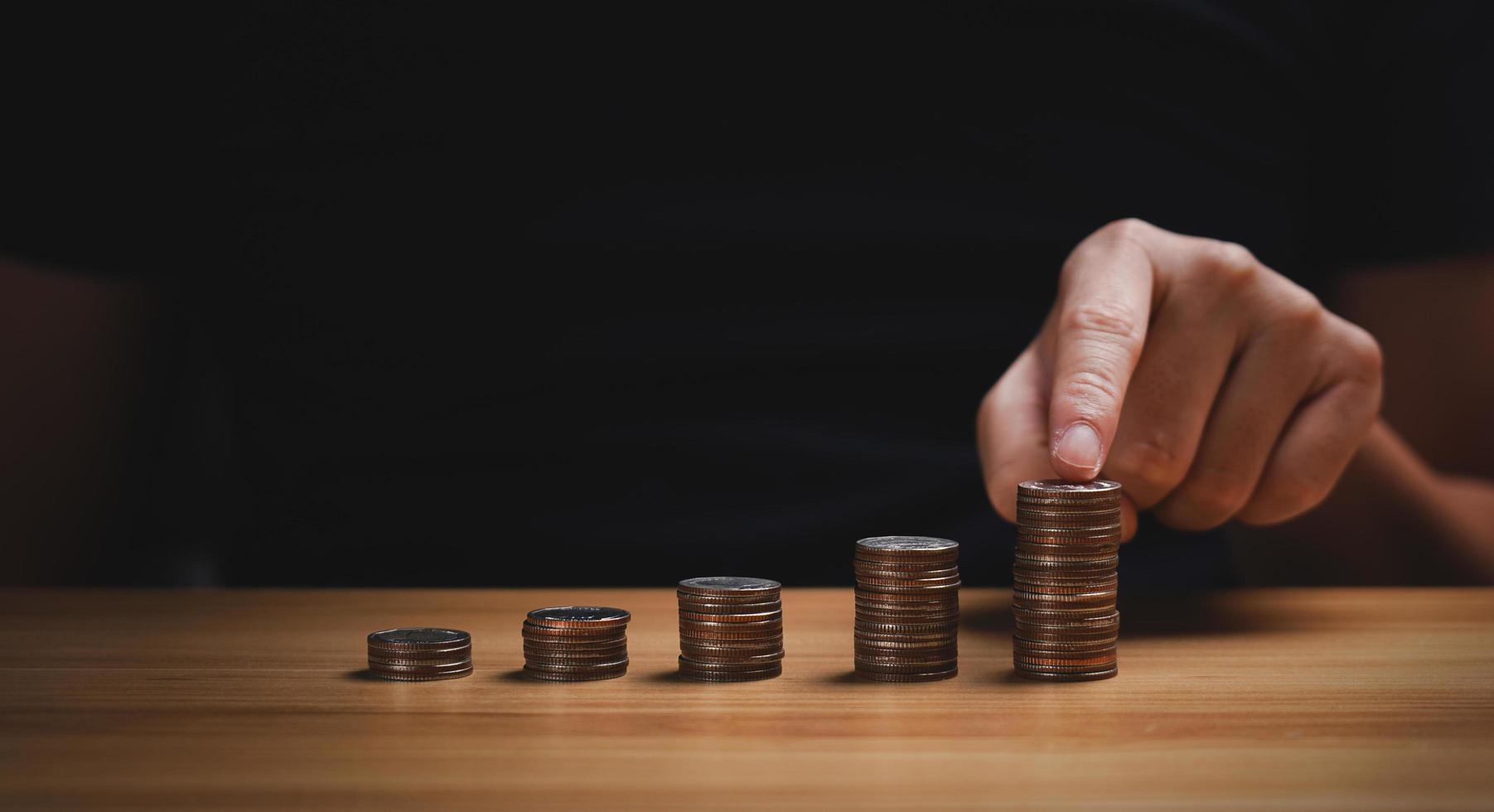 businessman stacking coins. save money and investment growth concept. Savings and pensions, collecting money, financial planning, save money for the future photo