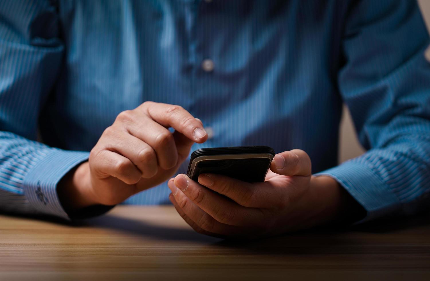 man's hand using a mobile phone browsing mobile device apps, reading news, chatting or shopping online, searching information in internet, holding smartphone, internet business, digital marketing photo