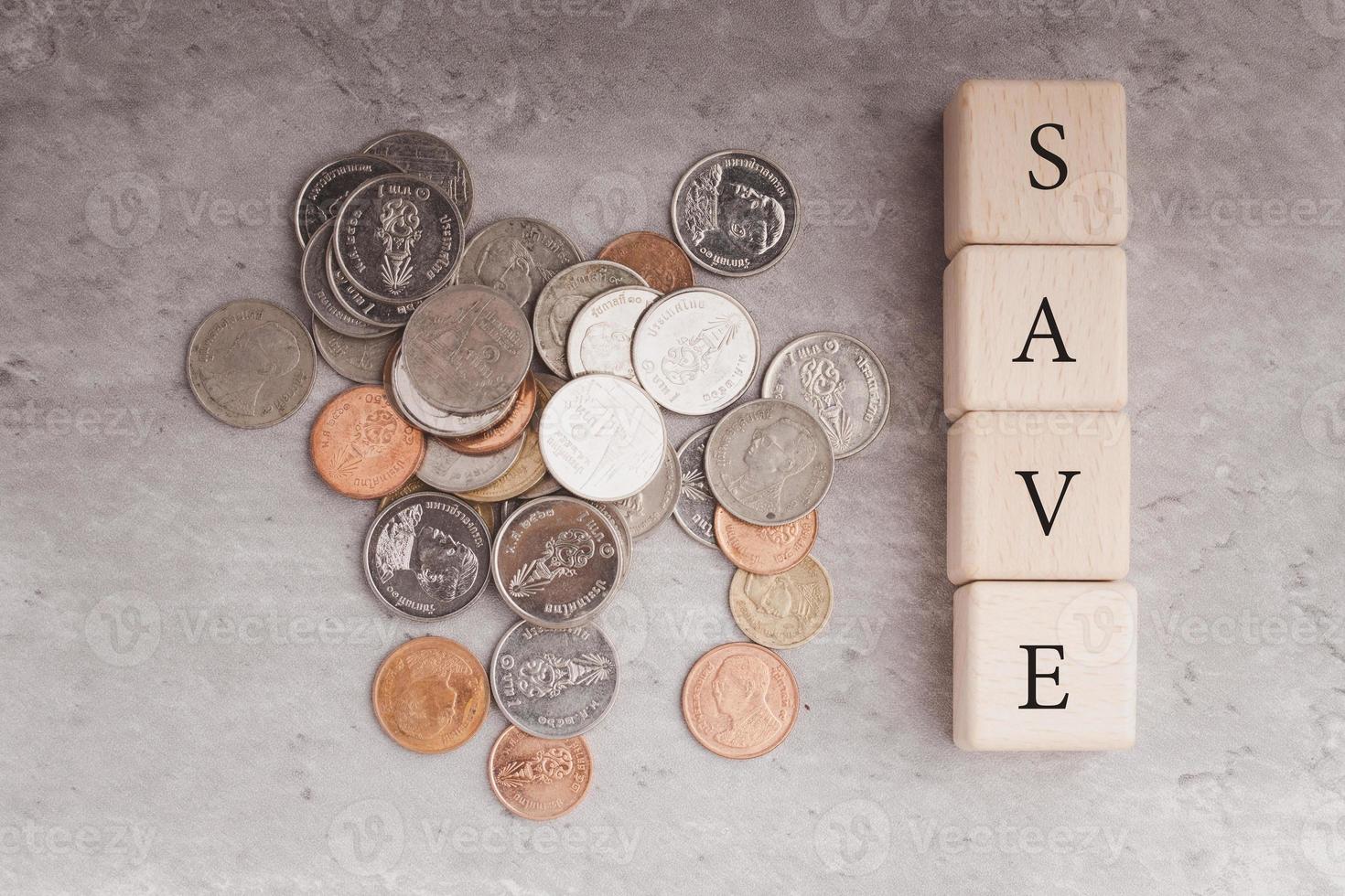 Wooden blocks and coins. Money saving concept. photo