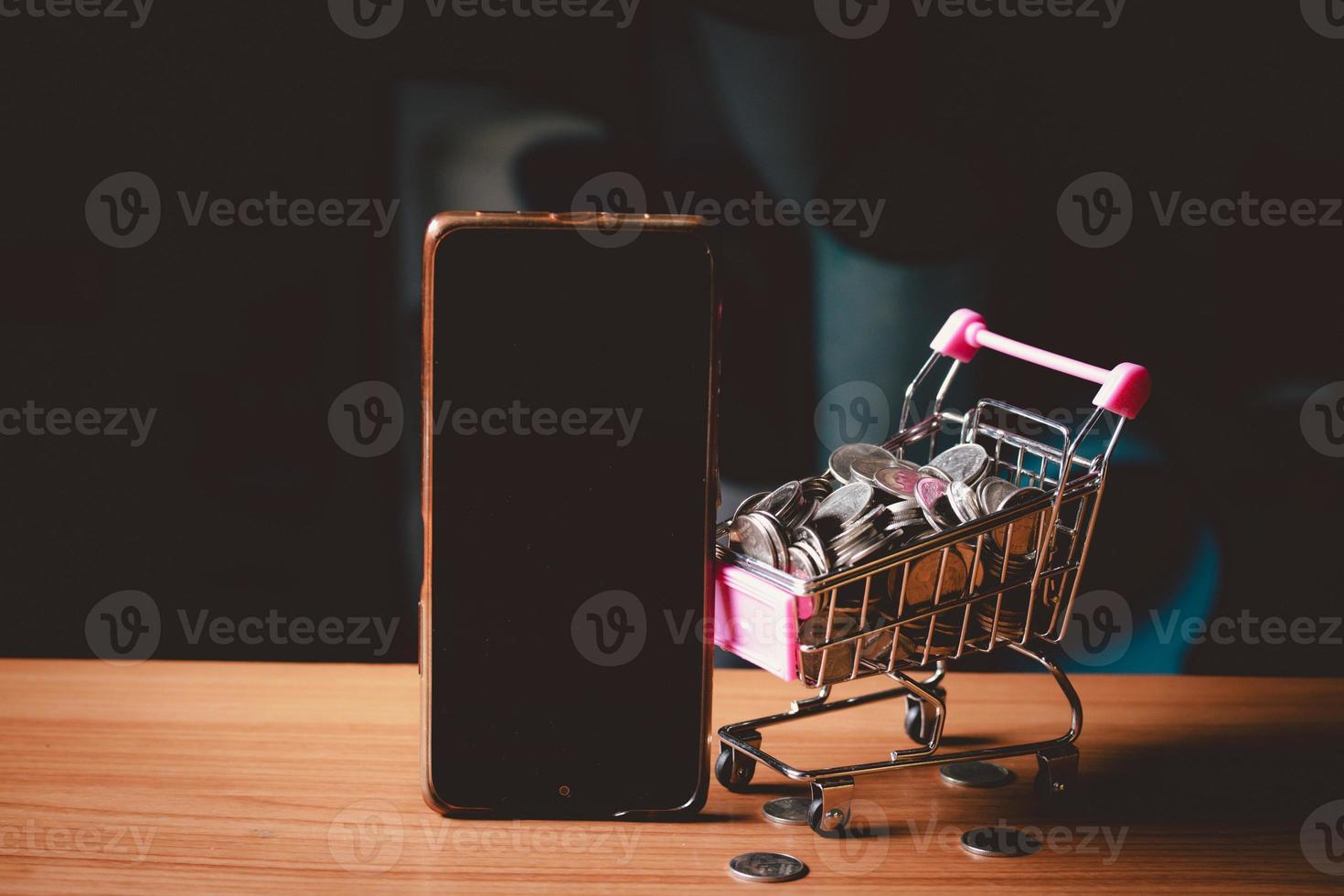 Mobile phone mockup beside coin basket.Online shopping concept. photo