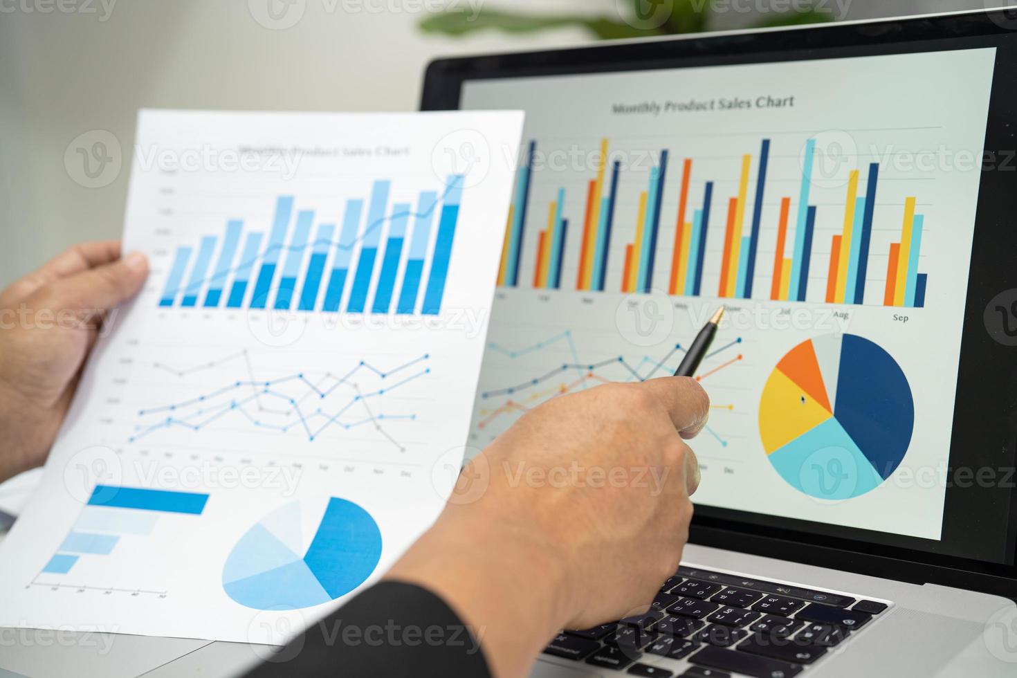 Asian accountant working and analyzing financial reports project accounting with chart graph and calculator in modern office, finance and business concept. photo