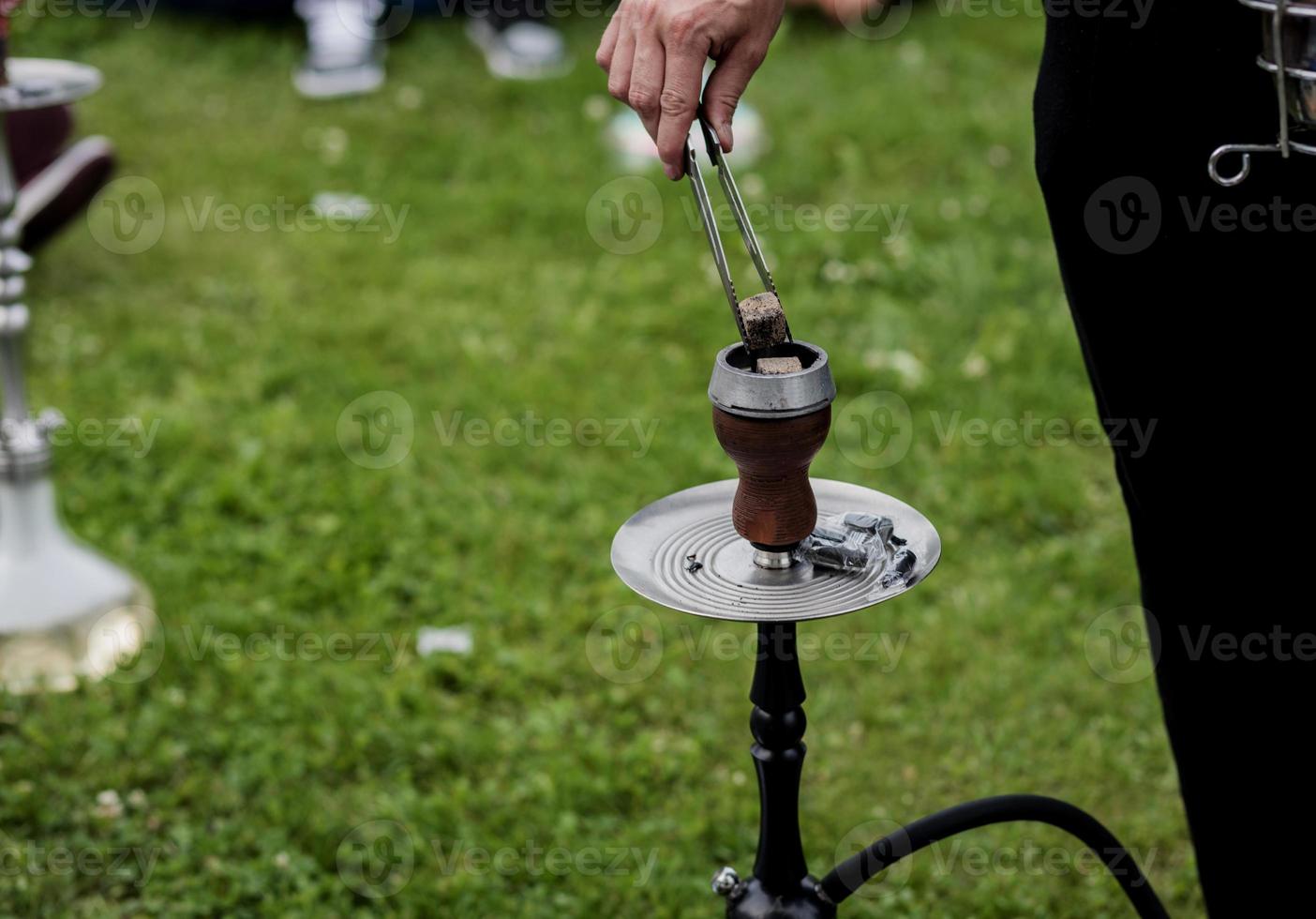 Modern hookah with coconut charcoal photo