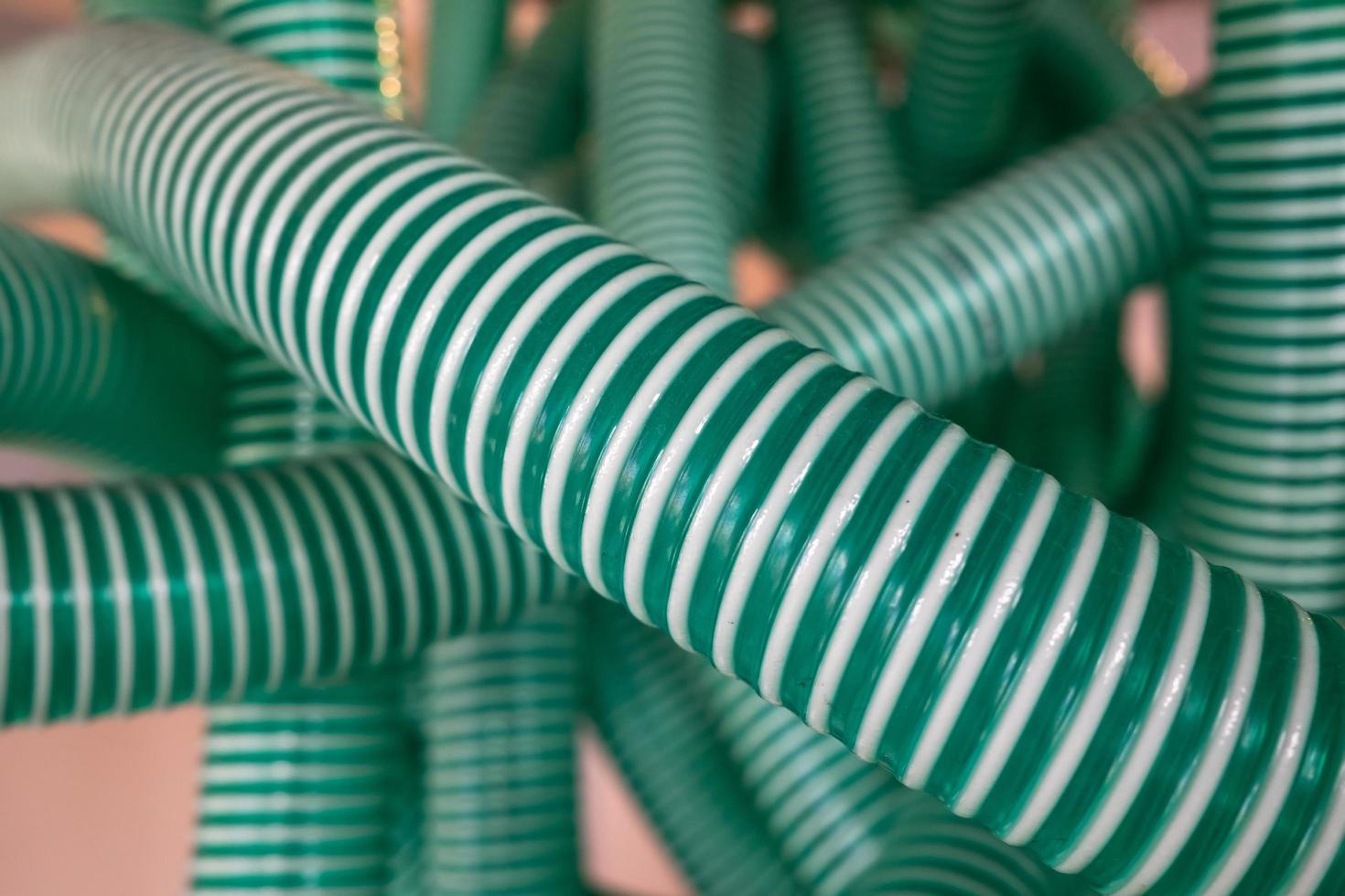 Corrugated pipe, green-white, used for industrial purposes. Flatley. photo