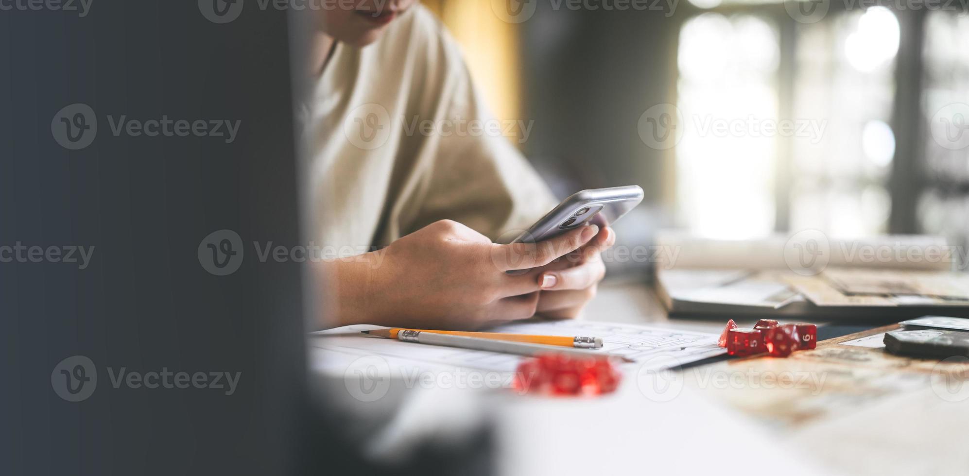 Woman hand typing smartphone for online board game community foreground
